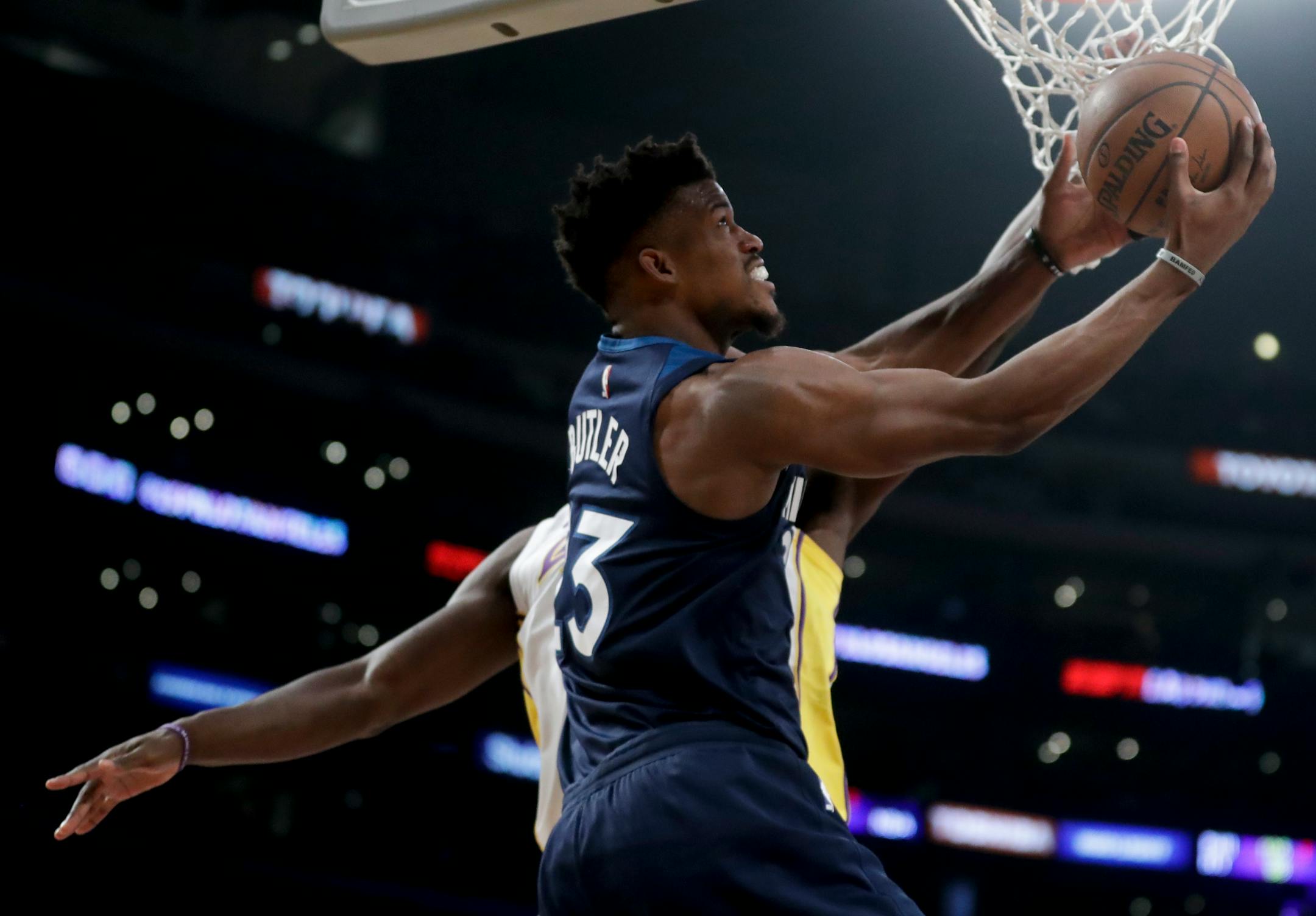 Minnesota Timberwolves guard Jimmy Butler (23) shoots around Los Angeles Lakers forward Julius Randle during the first half of an NBA basketball game in Los Angeles, Monday, Dec. 25, 2017. (AP Photo/Chris Carlson)