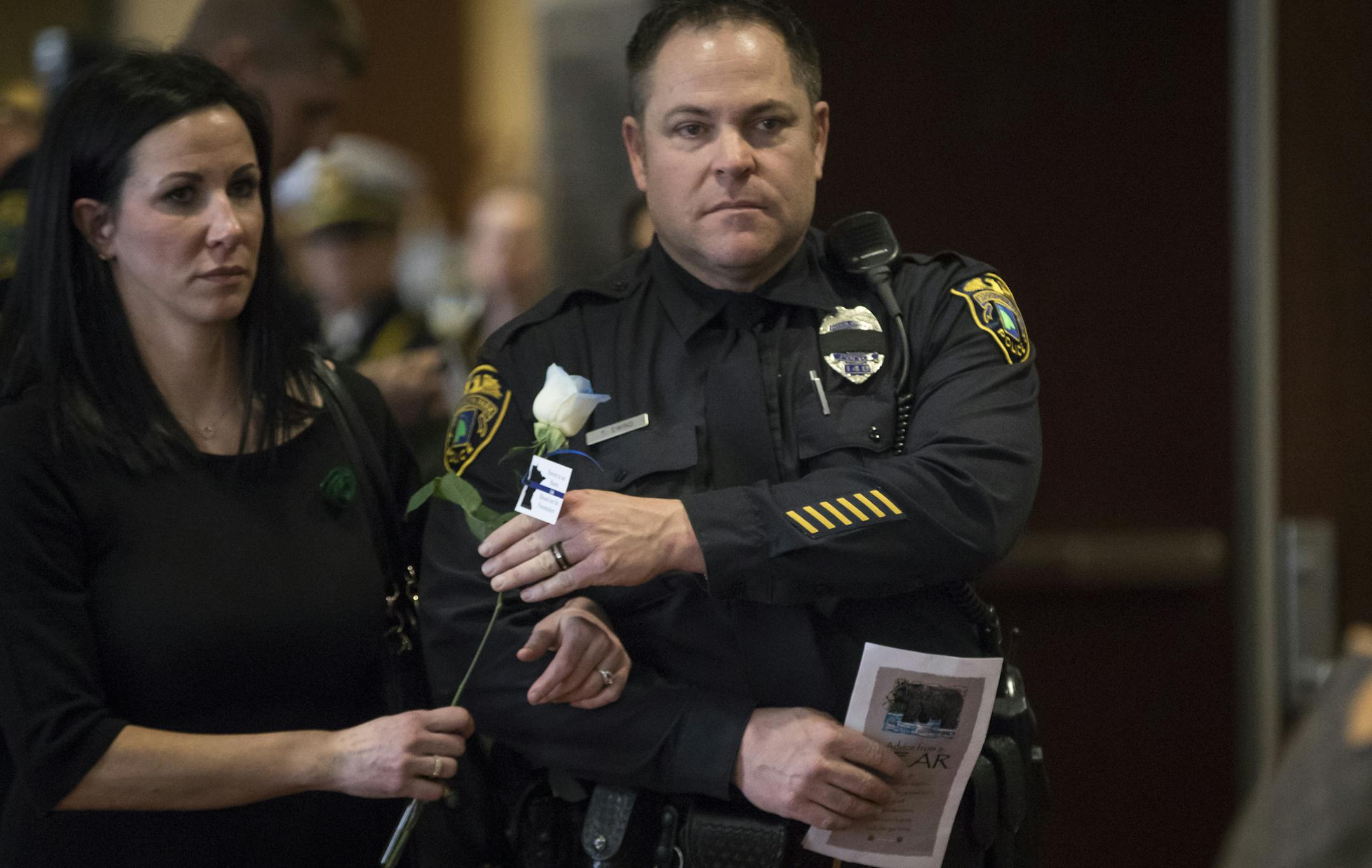 Officer Todd Ewing held a blue Rose as he walked into the funeral for fellow Officer Andrew Suerth on Friday, December 15, 2017, in Brooklyn Park, Minn. Ewing and two other officers went out of their way to fly to Colorado and drive back this week with their fellow officer's remains. ] RENEE JONES SCHNEIDER • renee.jones@startribune.com
