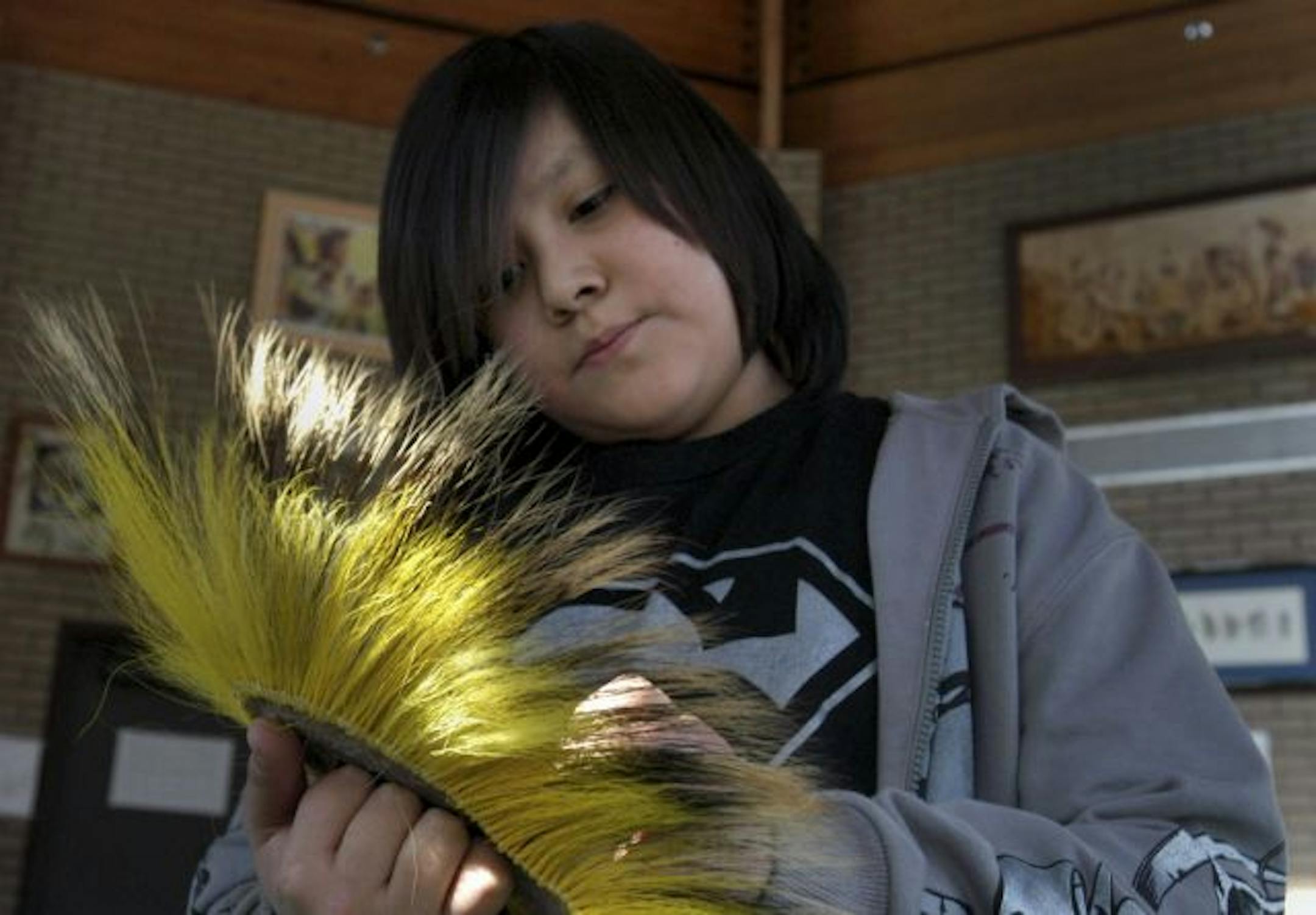 Casey Smith, 12, a sixth grader at Bug-O-Nay-Ge-Shig School near Bena, Mn. showed a visitor a head dress he might wear when dancing.