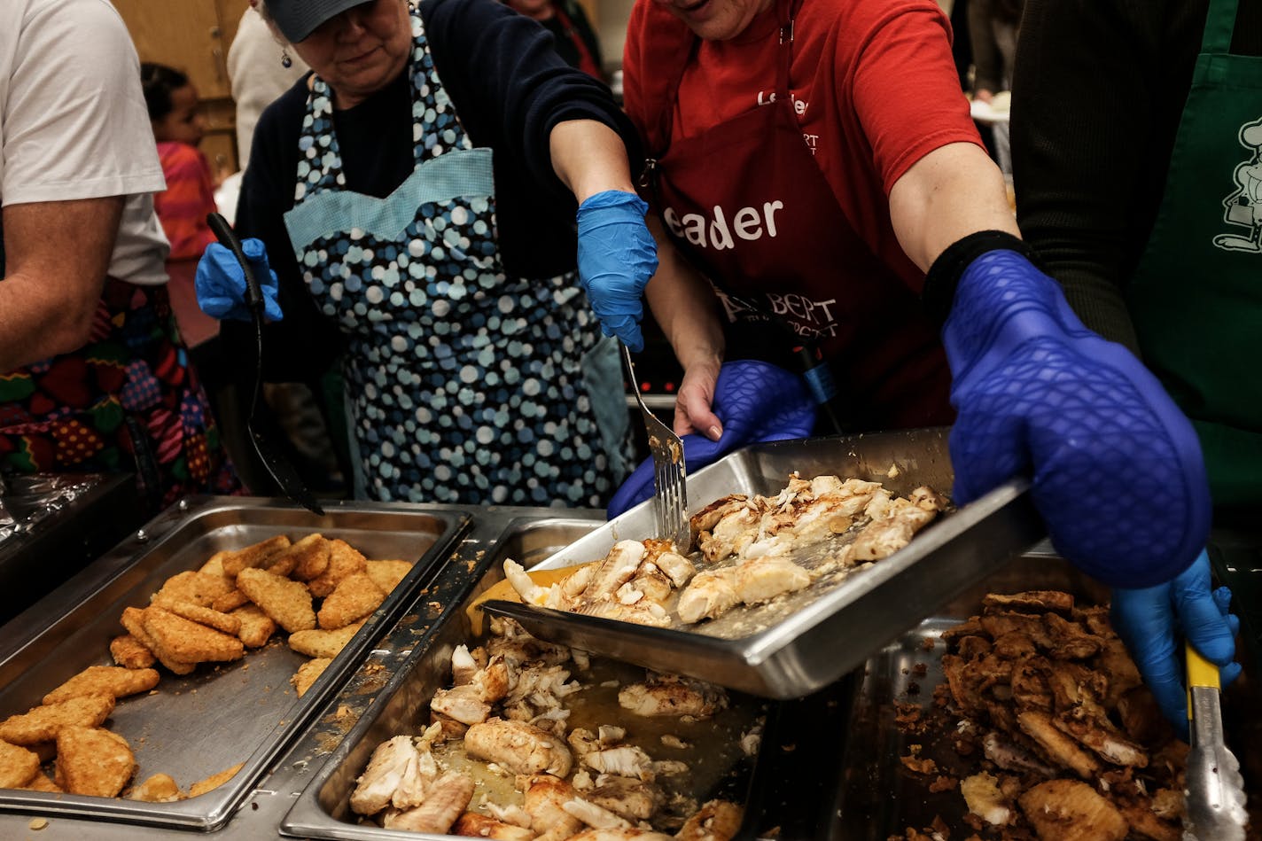 Freshly cooked tilapia was moved from the kitchen to the serving area Friday night at St. Albert the Great church in Minneapolis. ] AARON LAVINSKY &#xef; aaron.lavinsky@startribune.com Maple Grove played Grand Rapids in a boys' 2A quarterfinal hockey game on Thursday, March 9, 2017 at Xcel Energy Center in St. Paul, Minn.