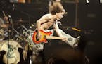Eddie Van Halen, shown in a 2004 concert in New Jersey playing the last chord of "Jump," died Oct. 6.
