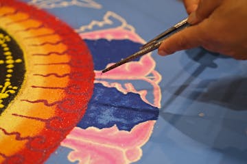 In Buddhist teachings, the concept of “near enemies” is a subtle way of understanding risk. File photo of a Buddhist mandala artist.