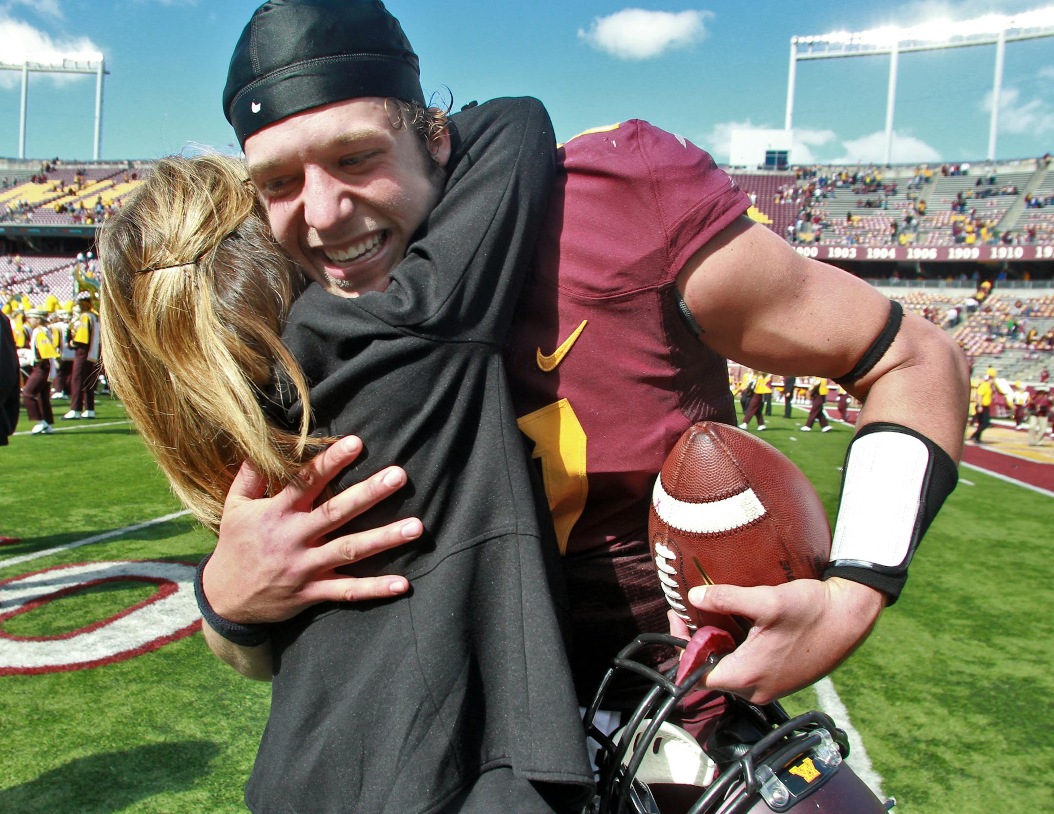 Rebecca Kill, wife of Gophers coach Jerry Kill, hugged quarterback Mitch Leidner at the end of Saturday's victory over San Jose State.