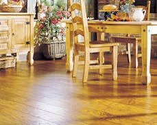 The latest hardwood styles are distressed, beveled, scratched with wormholes, and have a hand-hewn appearance, like this Biscotti style hardwood floor