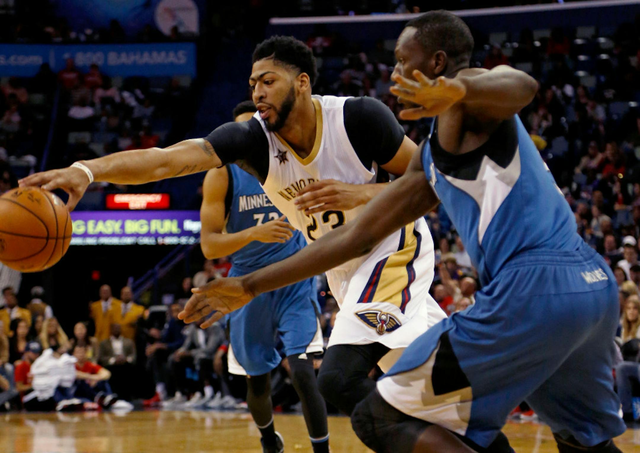 Pelicans forward Anthony Davis, left, reaches for a loose ball against Minnesota's Gorgui Dieng, right, during the first half Wednesday in New Orleans.