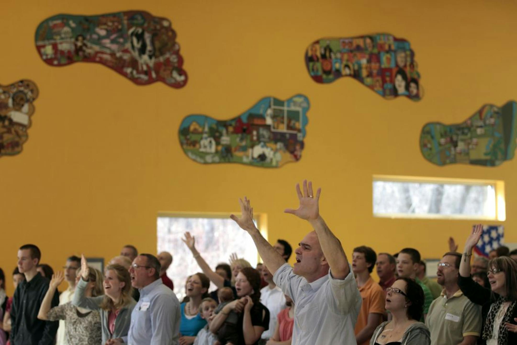 The Rev. Brett Louis pastor, at Christ Redeemer Church worshiped with members at the newly formed church that has it 's Sunday services at Footprints Academy in Woodbury, MN.