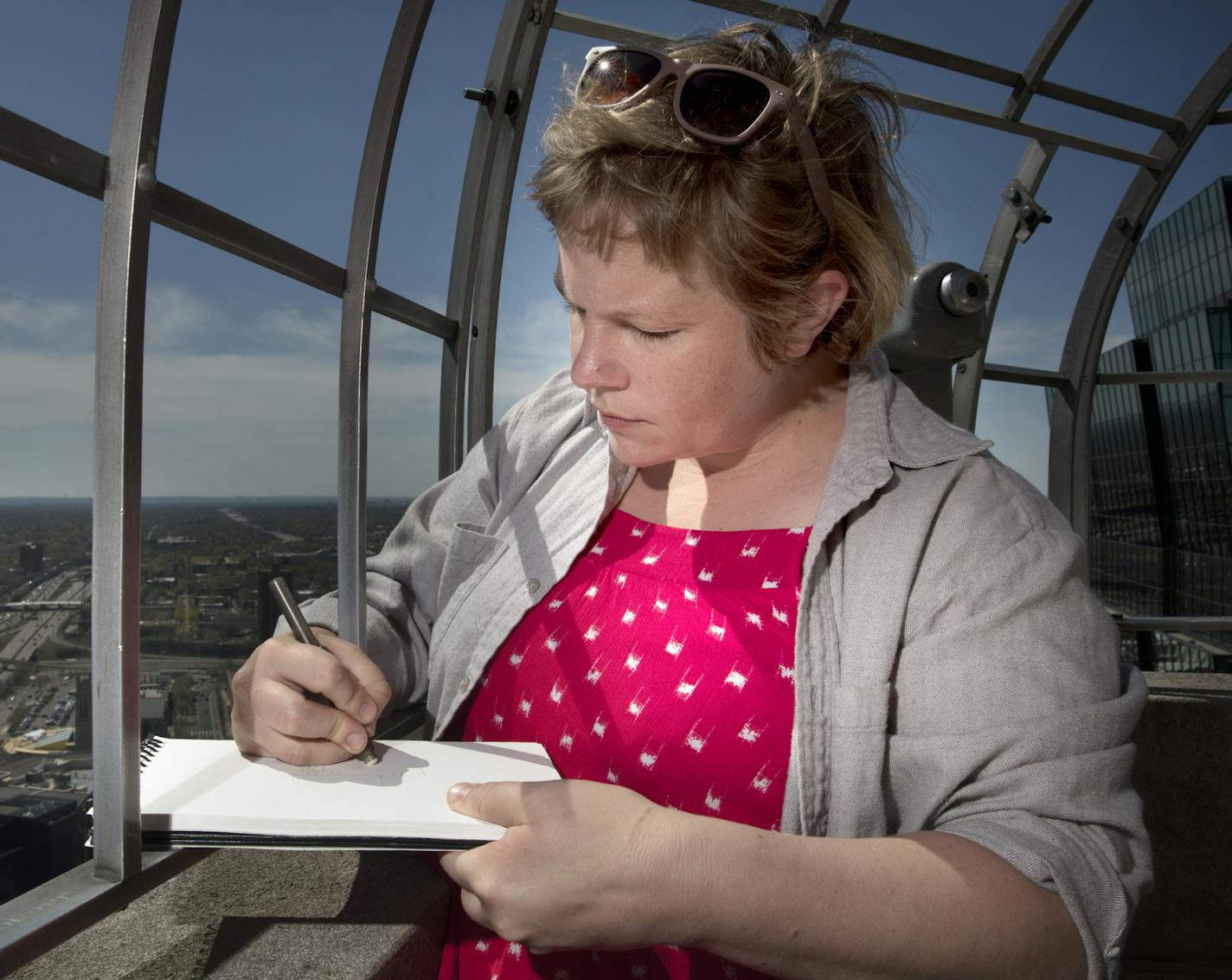 The M-PAC drawing class met on the Observation Deck of the Foshay Tower , Sunday, May 5, 2018. Kit Leffler, takes on drawing the eastern view of of the tower.