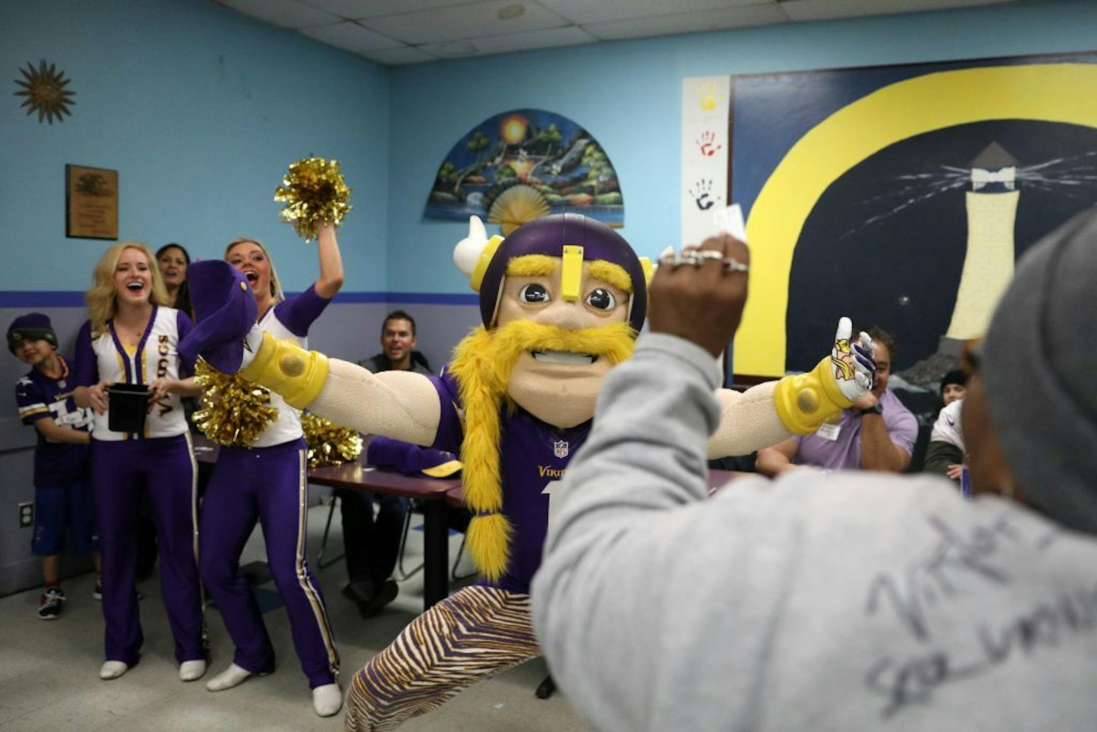Viktor the Viking and cheerleaders Gretta and Hannah celebrated with Charlotte Oriakhi, at right, after her number was called during a raffle Tuesday.