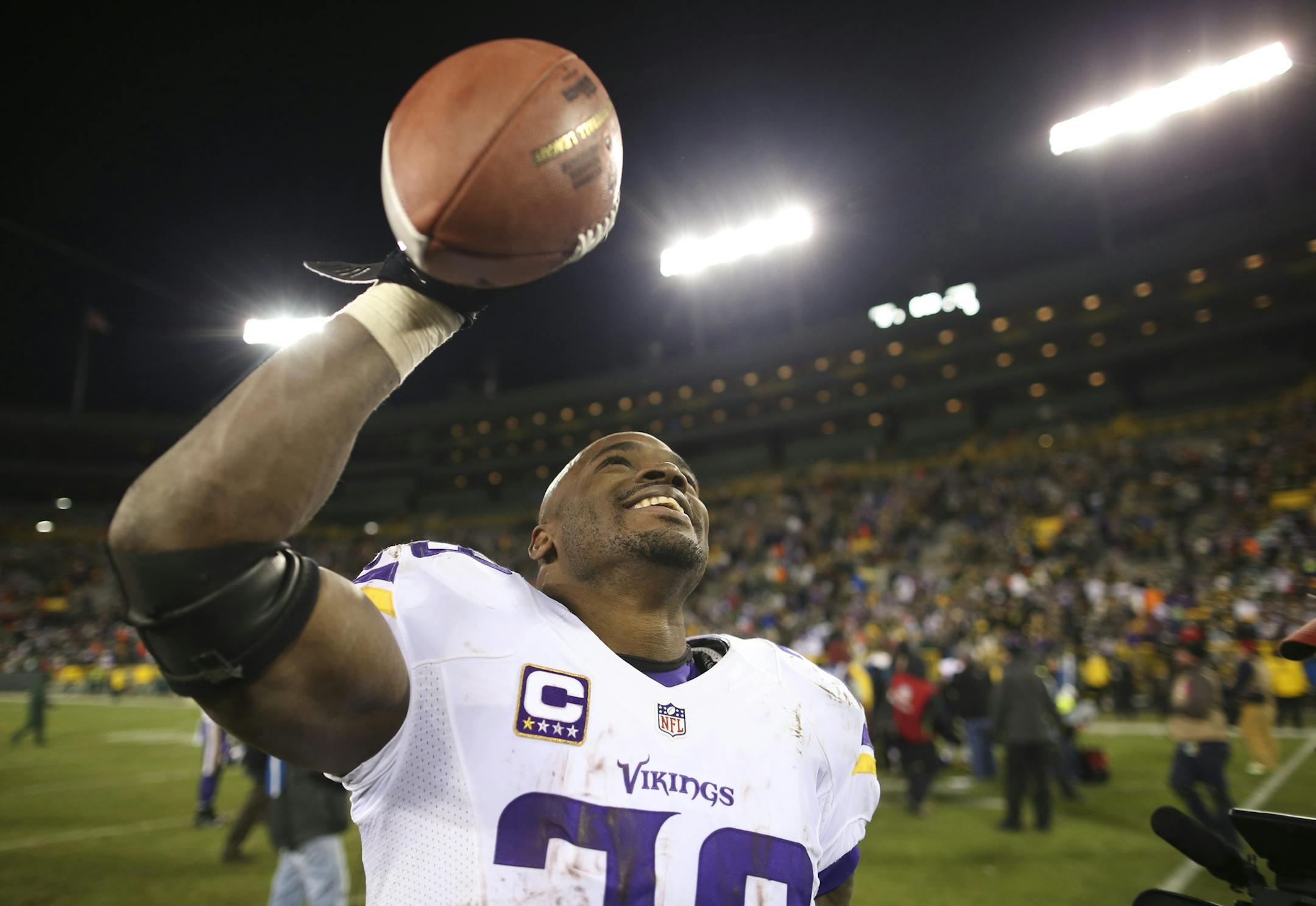 Vikings running back Adrian Peterson (28) held one of the game ball aloft as he walked off the field after the Vikings win Sunday night. ] JEFF WHEELER &#xef; jeff.wheeler@startribune.com The Minnesota Vikings beat the Green Bay Packers 20-13 in the final regular season game of season Sunday, January 3, 2016 at Lambeau Field in Green Bay, WI.