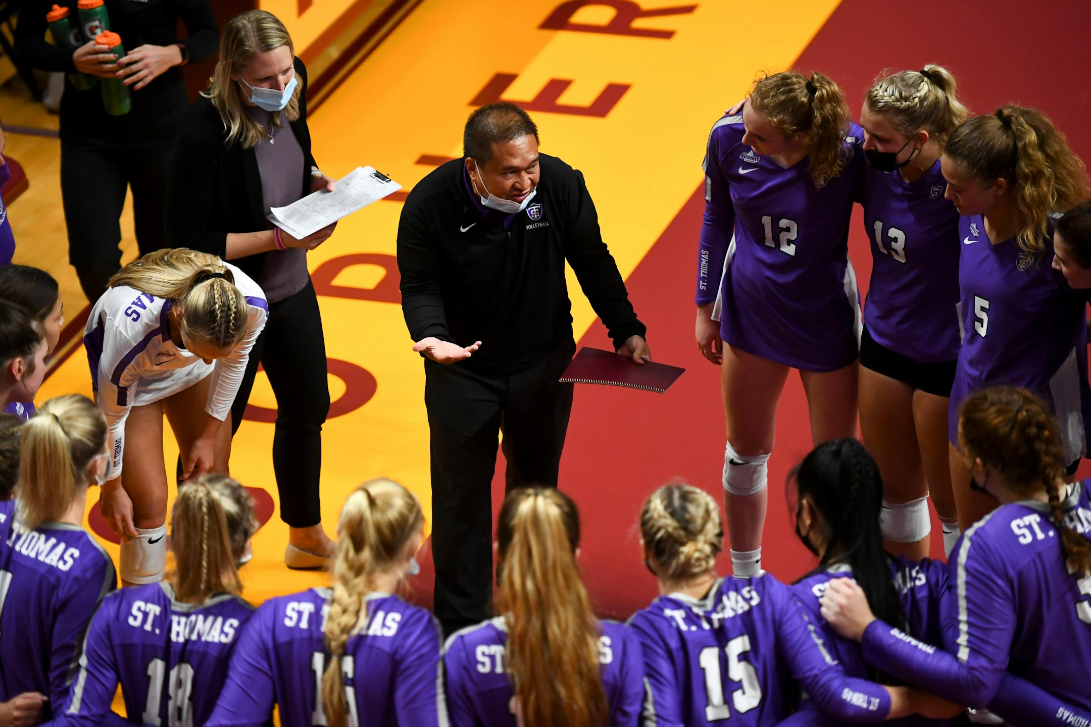 St. Thomas head coach Thanh Pham directed the team during a first set timeout against the University of Minnesota Gophers.