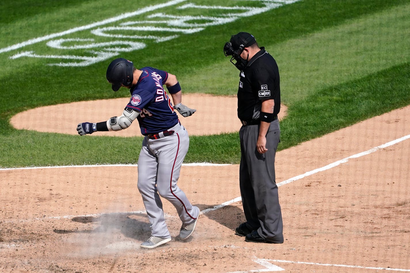 The Twins' Josh Donaldson kicks dirt on home plate after his home run prompting umpire Dan Bellino to eject him from the game during the sixth inning Thursday.