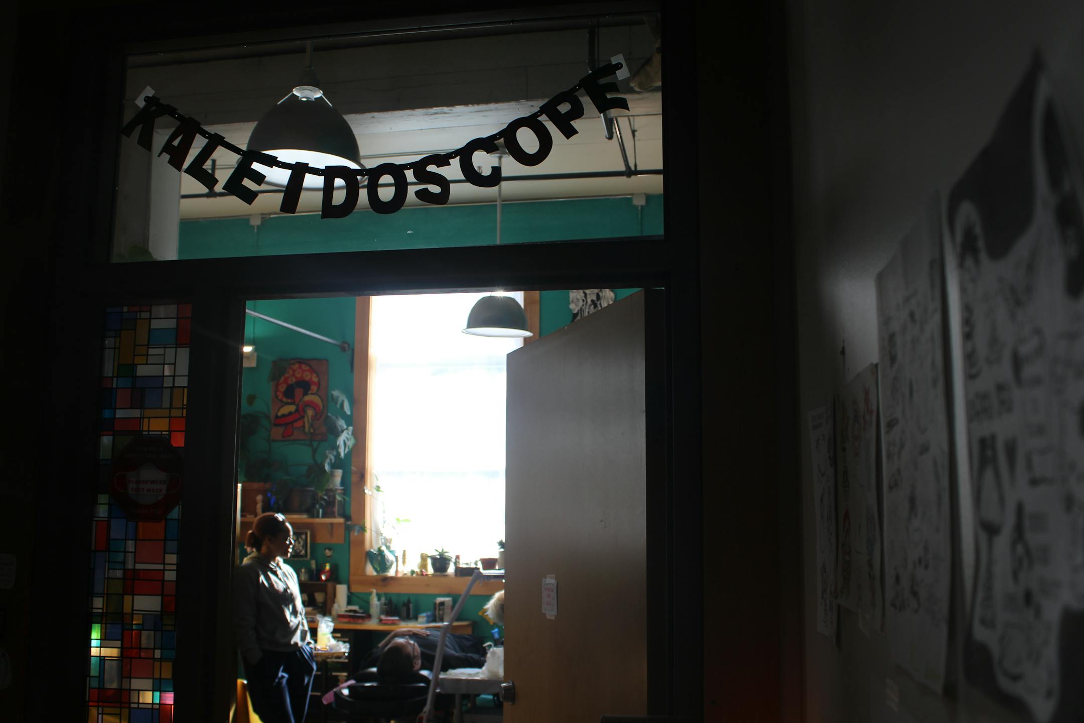 Bobby Wise lays down for a tattoo inside the Kaleidoscope Tattoo Collective, where dozens more inked similar designs to support families affected by immigration enforcement.