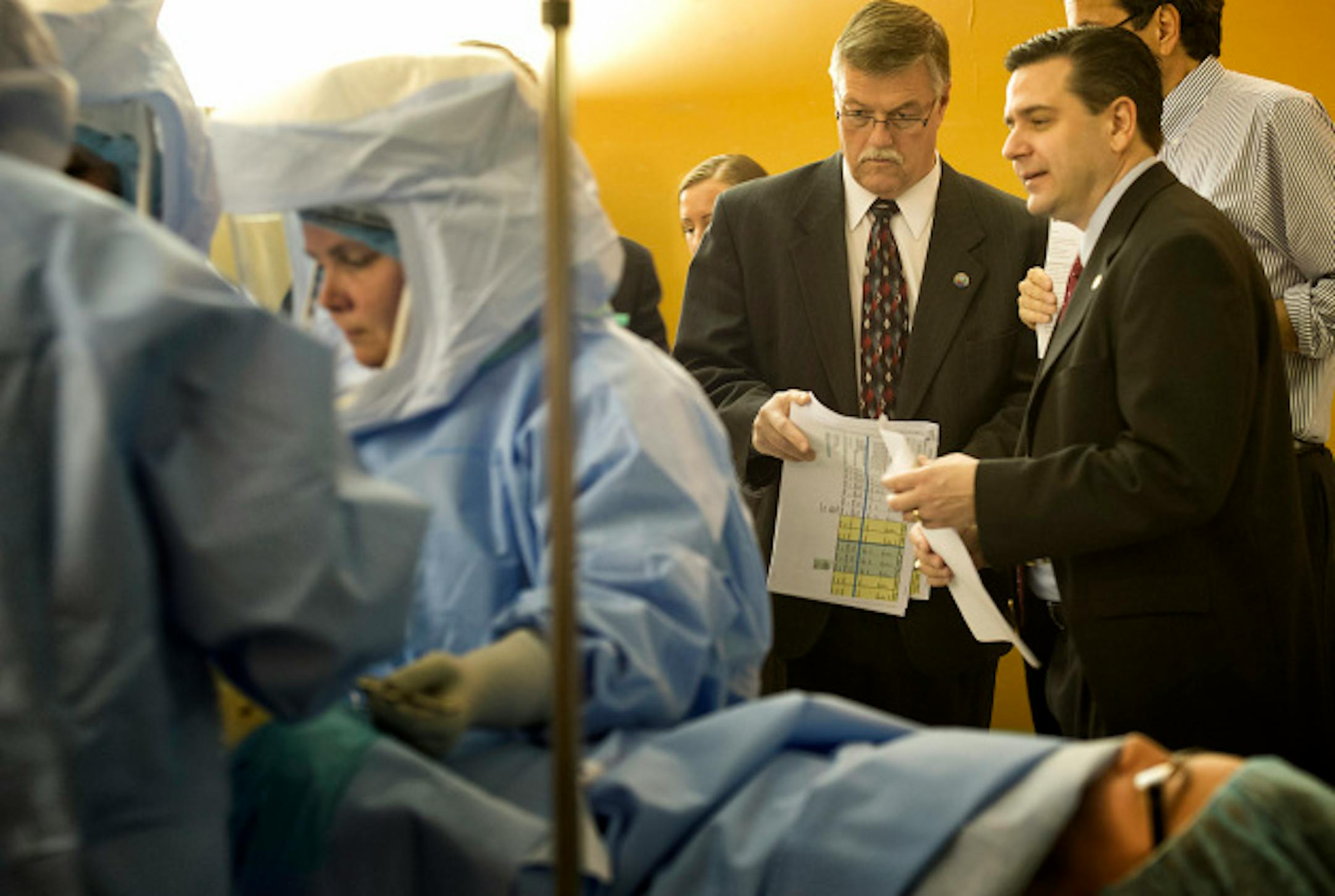 Senators Bill Ingebrightsen and Sean Nienow watched the mock knee replacement.  Surgical technologists and surgical technology students participated in a mock knee replacement procedure in the Great Hall of the Capitol Thursday, April 11, 2013 to bring attention to to bills that would ensure standards for the now unregulated profession.      ]   GLEN STUBBE * gstubbe@startribune.com