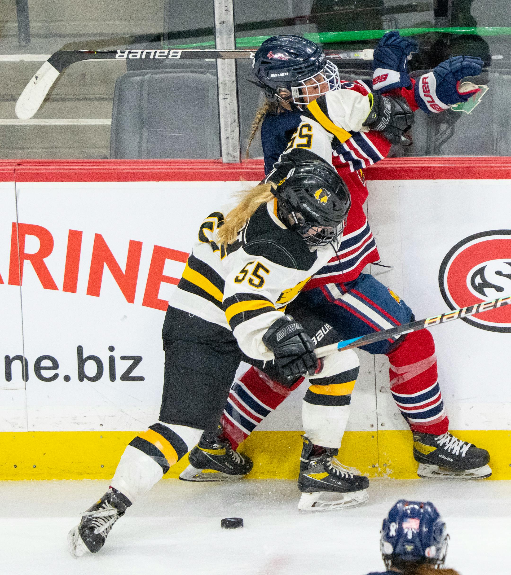 Warroad forward Lila Lanctot (55) hits Orono forward Josie Raiche (16) into the boards in the second period.