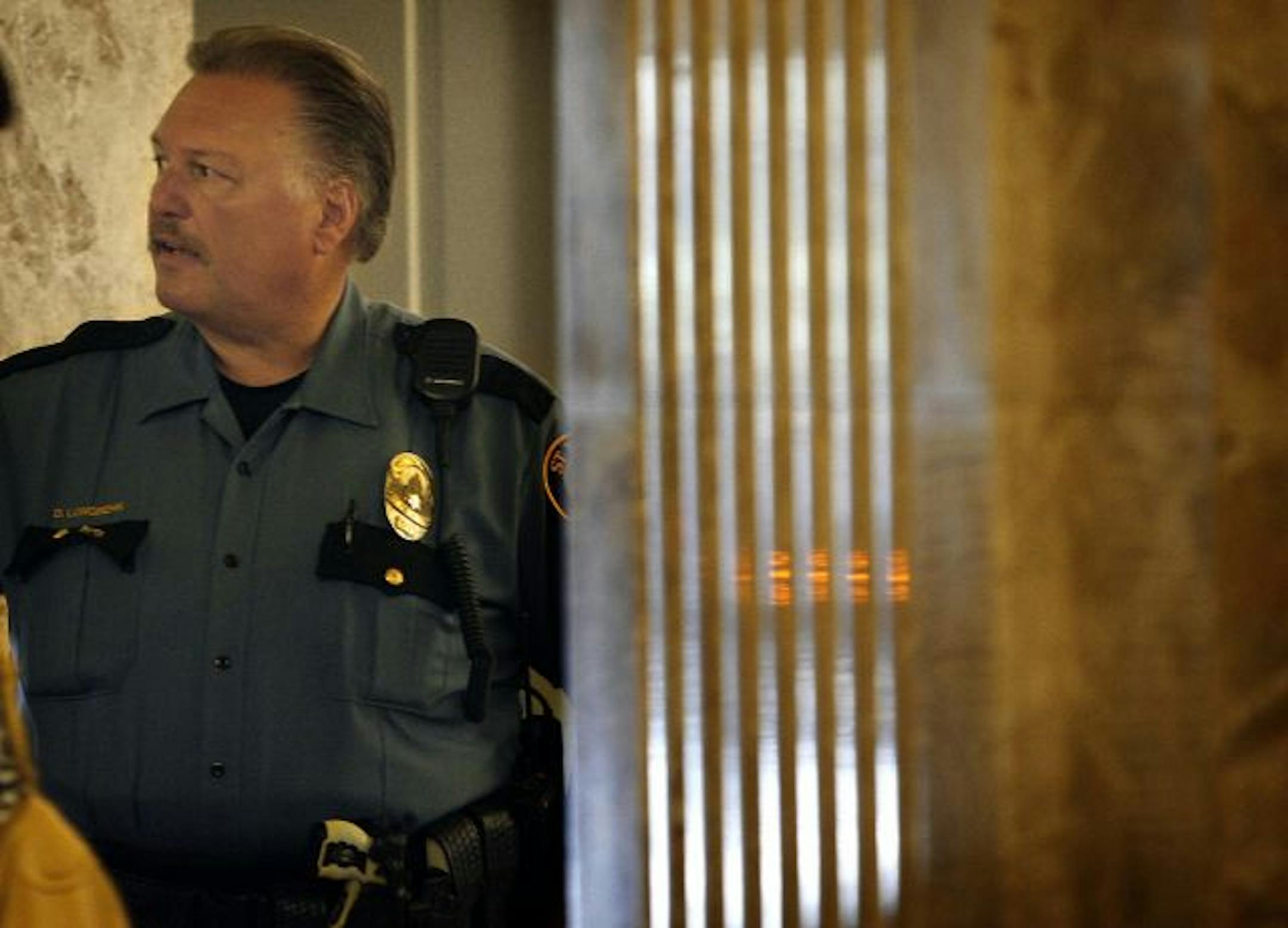St. Paul Police Officer David Longbehn waited in the courthouse lobby for an elevator to take him up to the hearing. Longbehn is the officer who shot a second suspect to death during a manhunt immediately after Bergeron was killed.