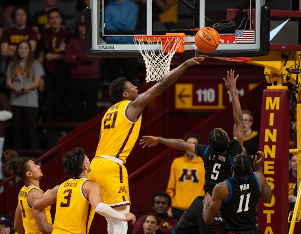 Gophers forward Pharrel Payne (21), above trying to block a shot vs. DePaul earlier this month, had 15 points and 13 rebounds in a 62-61 overtime win 