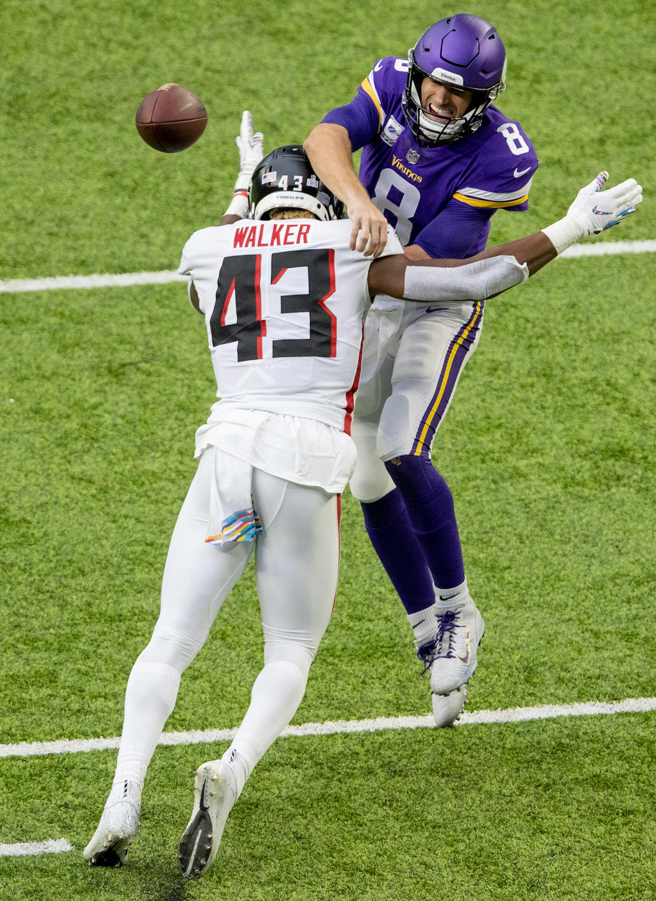 Minnesota Vikings quarterback Kirk Cousins (8) was pressured by Mykal Walker (43) of the Atlanta Falcons in the second quarter.