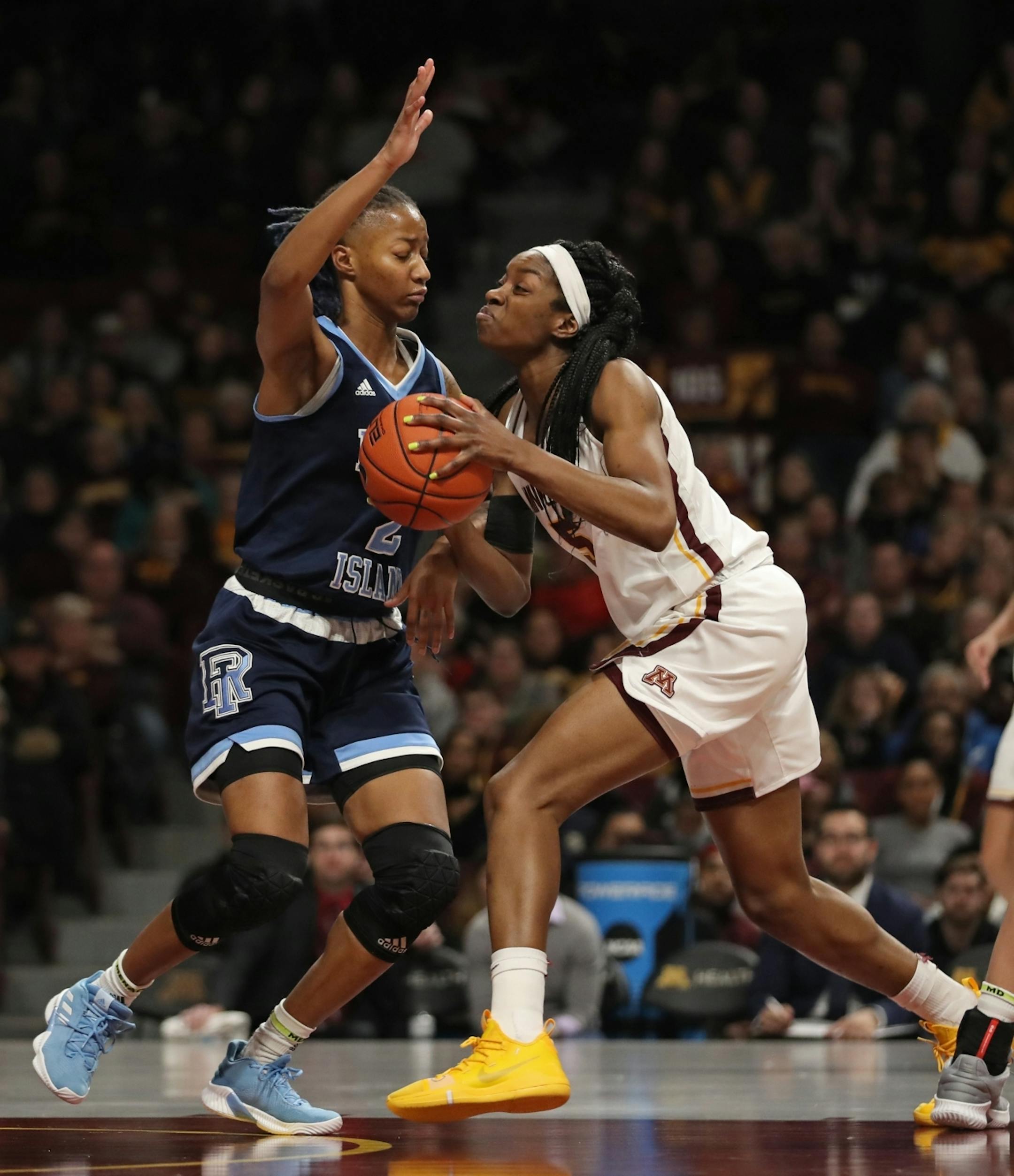 Minnesota Golden Gophers forward Taiye Bello (5) tried to drive the ball past Rhode Island Rams forward Jalissa Ross (2) in the second half. Bello had a double-double in the game with 16 points and 15 rebounds.