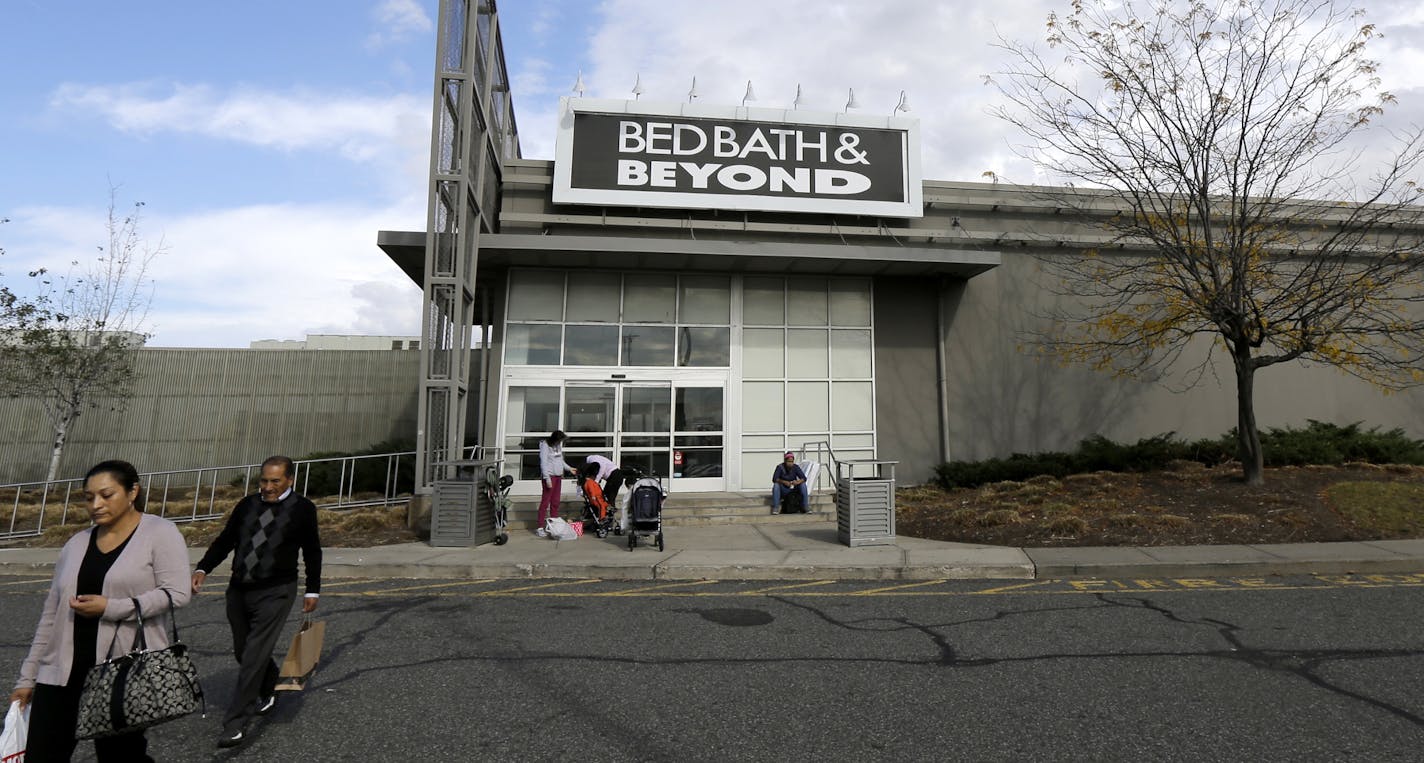 FILE- In this Oct. 25, 2017, file photo shoppers walk toward their vehicles outside of a Bed Bath &amp; Beyond department store at Jersey Gardens Mall in Elizabeth, N.J. Bed Bath &amp; Beyond's stock plunged to its lowest price in 18 years after the home goods store chain posted weak results in the second quarter and cut its forecasts for the rest of the year. The company's profit fell by almost 50 percent compared to a year ago. (AP Photo/Julio Cortez, File)