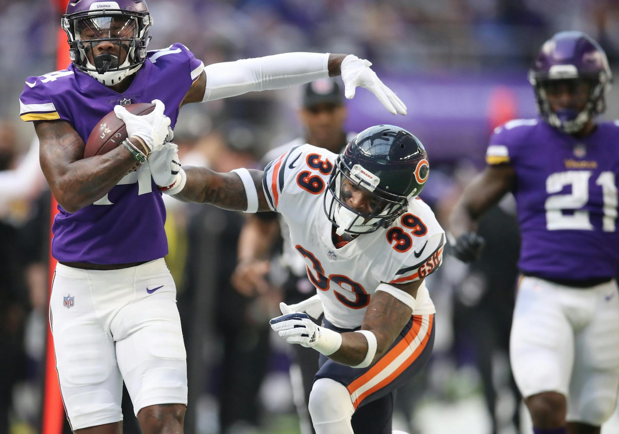 Minnesota Vikings wide receiver Stefon Diggs (14) picked up 27 yards on a catch and run and was pushed out of bounds Chicago Bears free safety Eddie Jackson (39) in the first quarter at U.S. Bank Stadium Sunday December 31, 2017 in Minneapolis, MN.