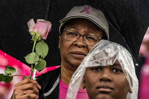 Cancer survivor Lois Scott, 59, with her grandson Savion Murray,10, stand in memory of her mother and sister who passed away from cancer.