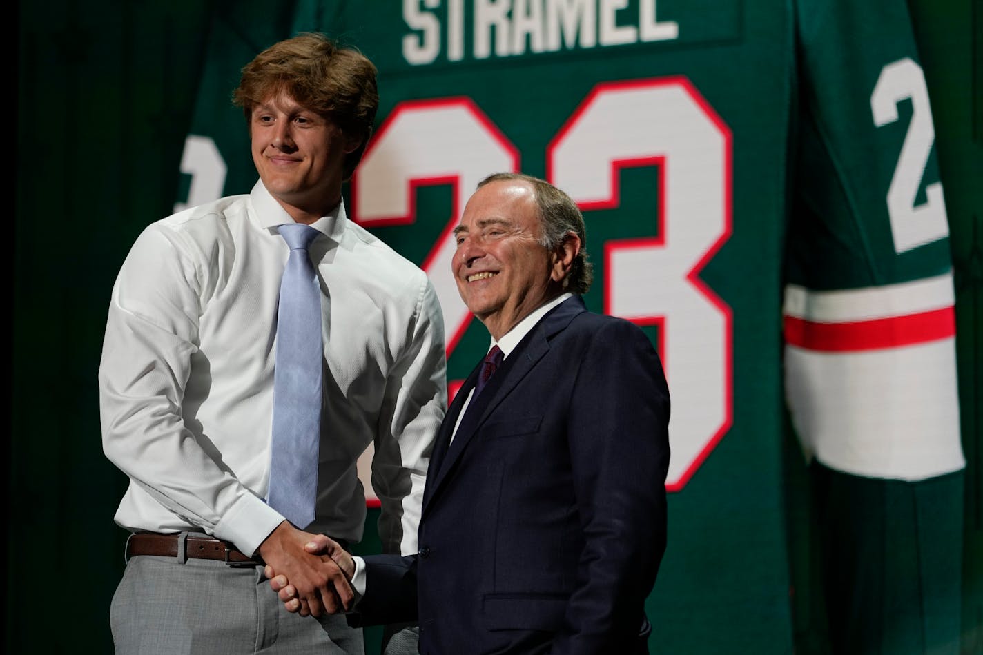 Charlie Stramel shakes hands with commissioner Gary Bettman after being selected by the Minnesota Wild during the first round of the NHL hockey draft Wednesday, June 28, 2023, in Nashville, Tenn. (AP Photo/George Walker IV)