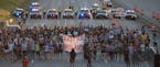 Marchers block part of Interstate 94 in St. Paul, Minn., Saturday, July 9, 2016, during a protest sparked by the recent police killings of black men i