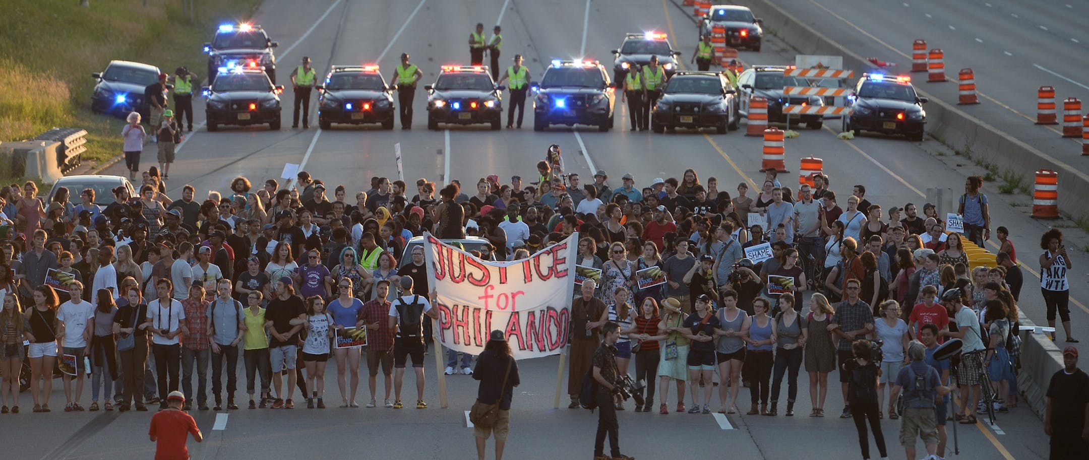 Marchers block part of Interstate 94 in St. Paul, Minn., Saturday, July 9, 2016, during a protest sparked by the recent police killings of black men in Minnesota and Louisiana. (Glen Stubbe/Star Tribune via AP)