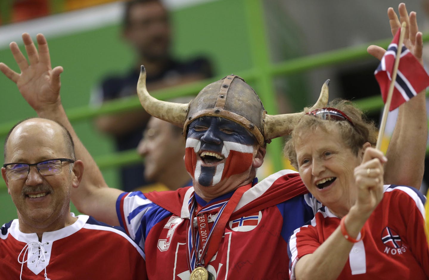 FILE - In this Thursday, Aug. 18, 2016 file photo Norwegian fans wait for the beginning of the women's semifinal handball match between Norway and Russia at the 2016 Summer Olympics in Rio de Janeiro, Brazil. A global happiness report has made the Norwegian foreign minister, well, happy. Reacting to the news Monday that Norway tops the world happiness rankings, edging out Denmark which was No.1 in the previous report. (AP Photo/Matthias Schrader)