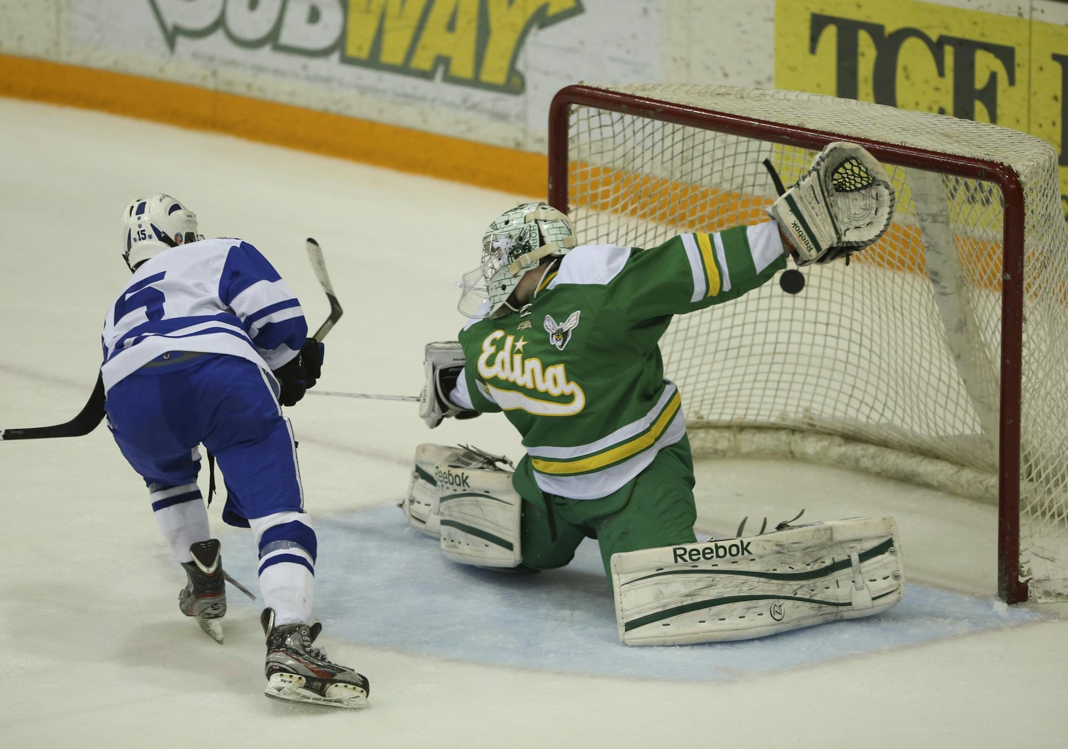 St. Thomas Academy's Tom Novak lifted the puck over the leg pad of Edina goaltender Willie Benjamin for the winning goal in overtime Wednesday night, giving a Class 1A power a victory over a 2A power in the Schwan Cup.