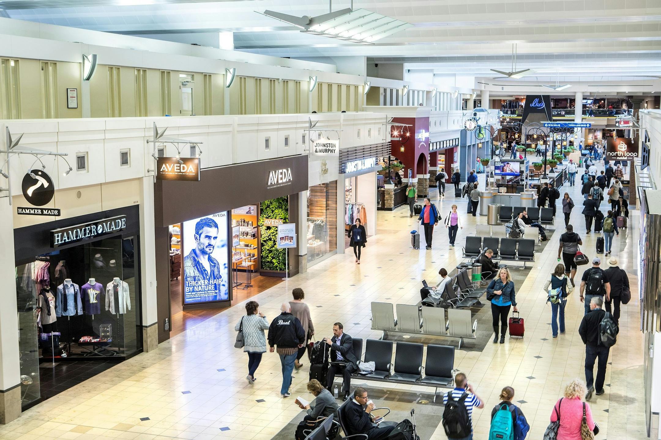 Air travelers pass through one of the main shopping areas in Terminal 1 at the Minneapolis-St. Paul International Airport. The airport remade its retail and restaurant offerings this year, with 50 new stores and about 30 new restaurants.