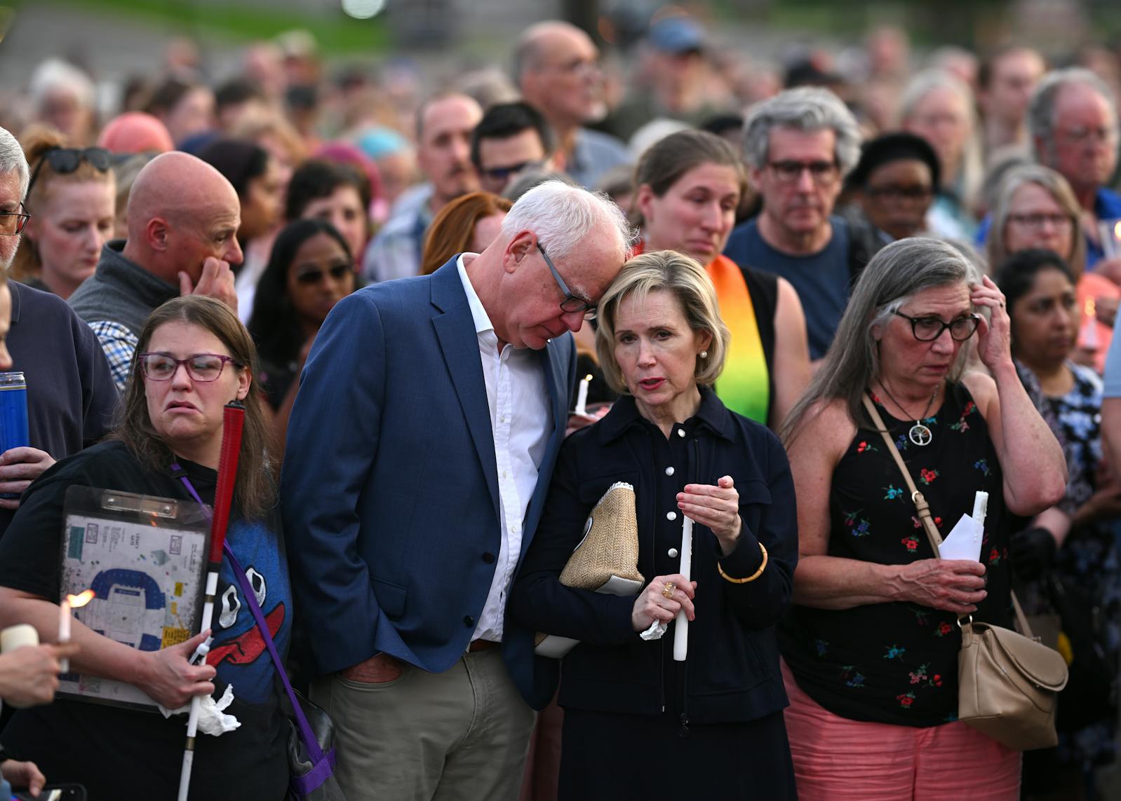 Gov. Tim Walz and wife Gwen stand with the crowd during a candlelight vigil for Melissa and Mark Hortman at the State Capitol building in St Paul on Wednesday.
