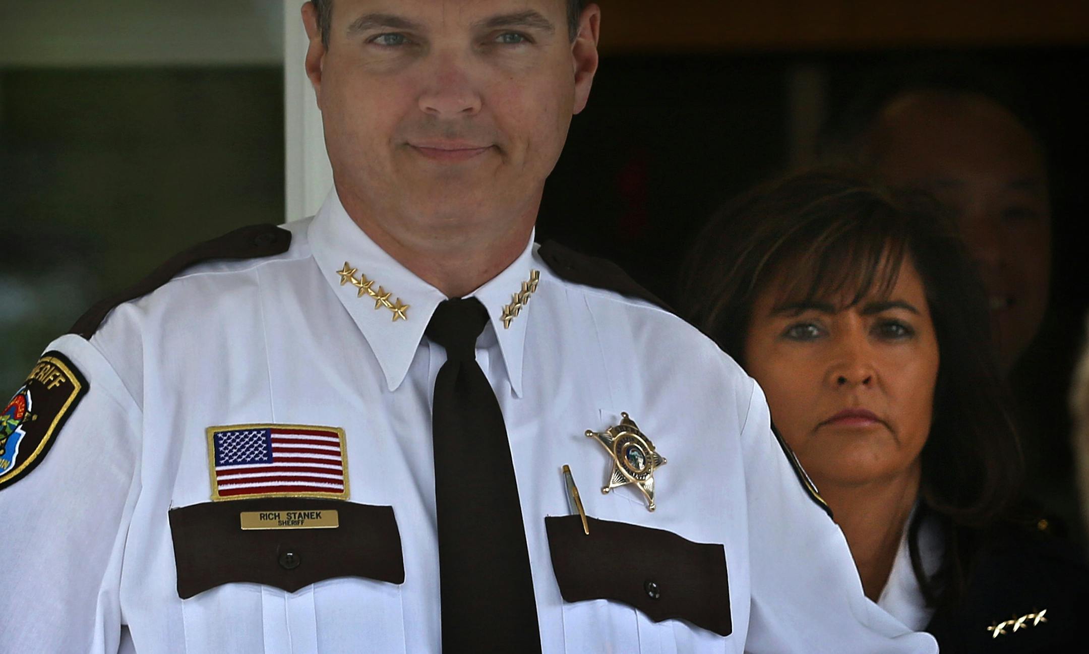 Hennepin County Sheriff Rich Stanek (left), Minneapolis Police Chief Jane&#x221a;&#xa9; Harteau and others gathered outside the Minneapolis Police 4th Precinct to brief members of the media on a series of summer crime strategies, which included: aggressive federal prosecution for gun violence crimes, Joint Enforcement Teams (JET), School Resource Officers on bike patrol, and faith patrols. At right is Bishop Richard D. Howell, Jr. from the Shiloh Temple International Ministries in Minneapolis. ]