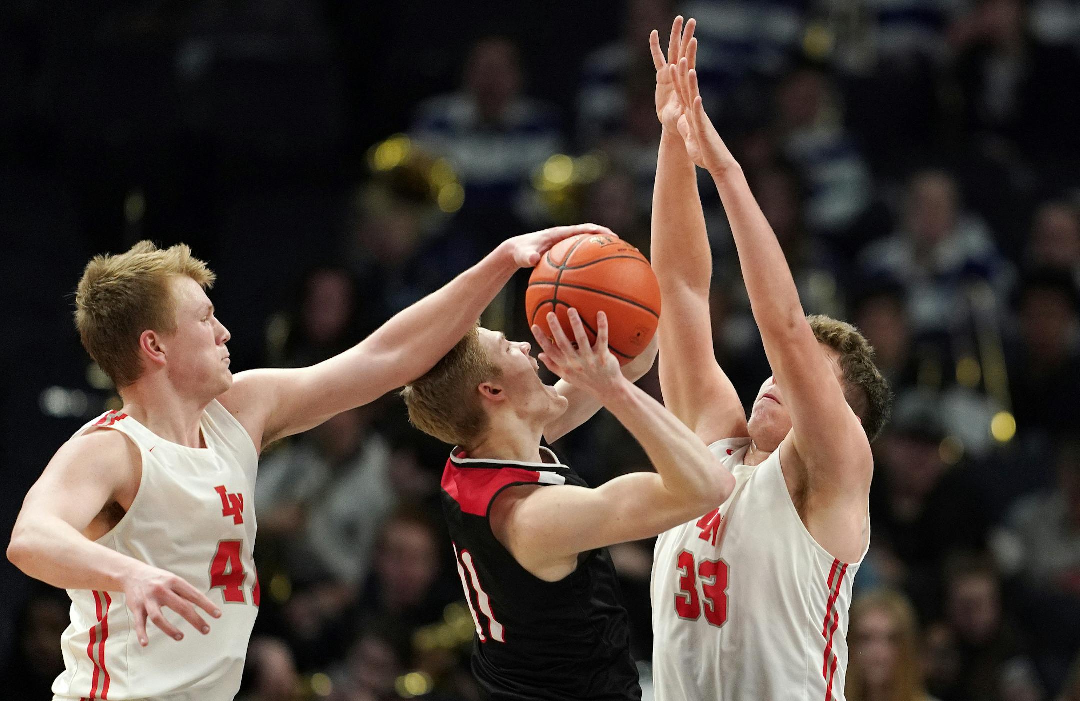 Eden Prairie guard Drake Dobbs (11) went up for a shot as Lakeville North forward Tate Staloch (41) and Lakeville North forward Will Mostaert (33) defended in the second half. ] ANTHONY SOUFFLE • anthony.souffle@startribune.com Lakeville North High School played Eden Prairie High School in a MSHSL boys' basketball quarterfinal game Wednesday, March 20, 2019 at the Target Center in Minneapolis.
