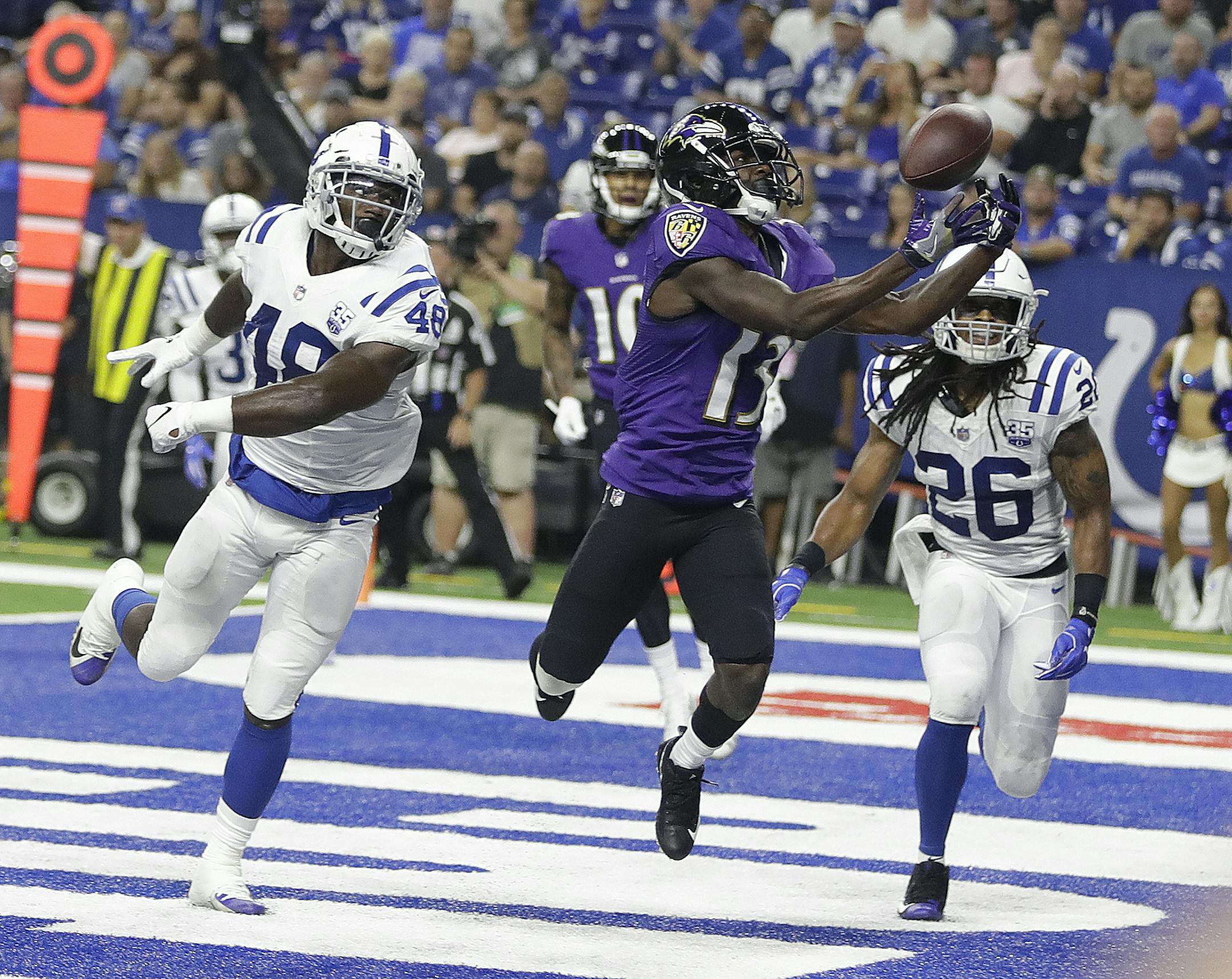 Baltimore Ravens wide receiver John Brown (13) makes a catch for a touchdown in front of Indianapolis Colts linebacker Skai Moore (48) and defensive back Clayton Geathers (26) in the first half of an NFL preseason football game in Indianapolis, Monday, Aug. 20, 2018. (AP Photo/Darron Cummings)