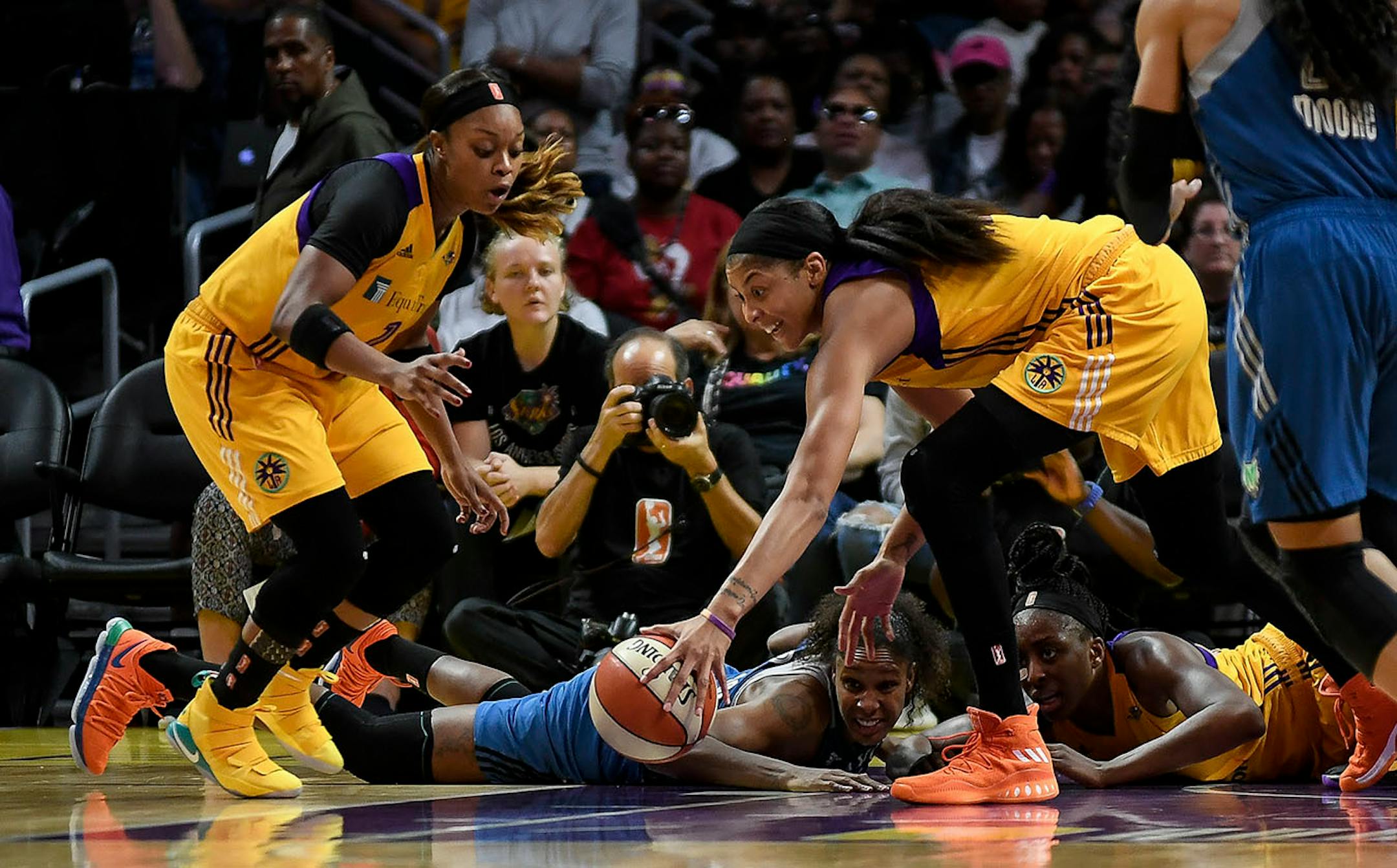 Los Angeles Sparks forward Candace Parker (3) scooped a ball knocked loose from Minnesota Lynx forward Rebekkah Brunson (32) by Los Angeles Sparks forward Nneka Ogwumike (30) in the third quarter Sunday.