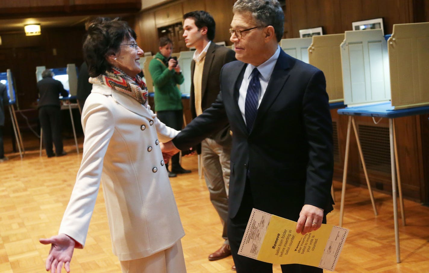 Sen. Al Franken, D-Minn. gets a hug from his wife Franni as he waits to put his ballot in the counter after he voted at Westminster Presbyterian Church, Tuesday, Nov. 4, 2014, in Minneapolis. Franken faces Republican businessman Mike McFadden in the election. (AP Photo/Jim Mone)