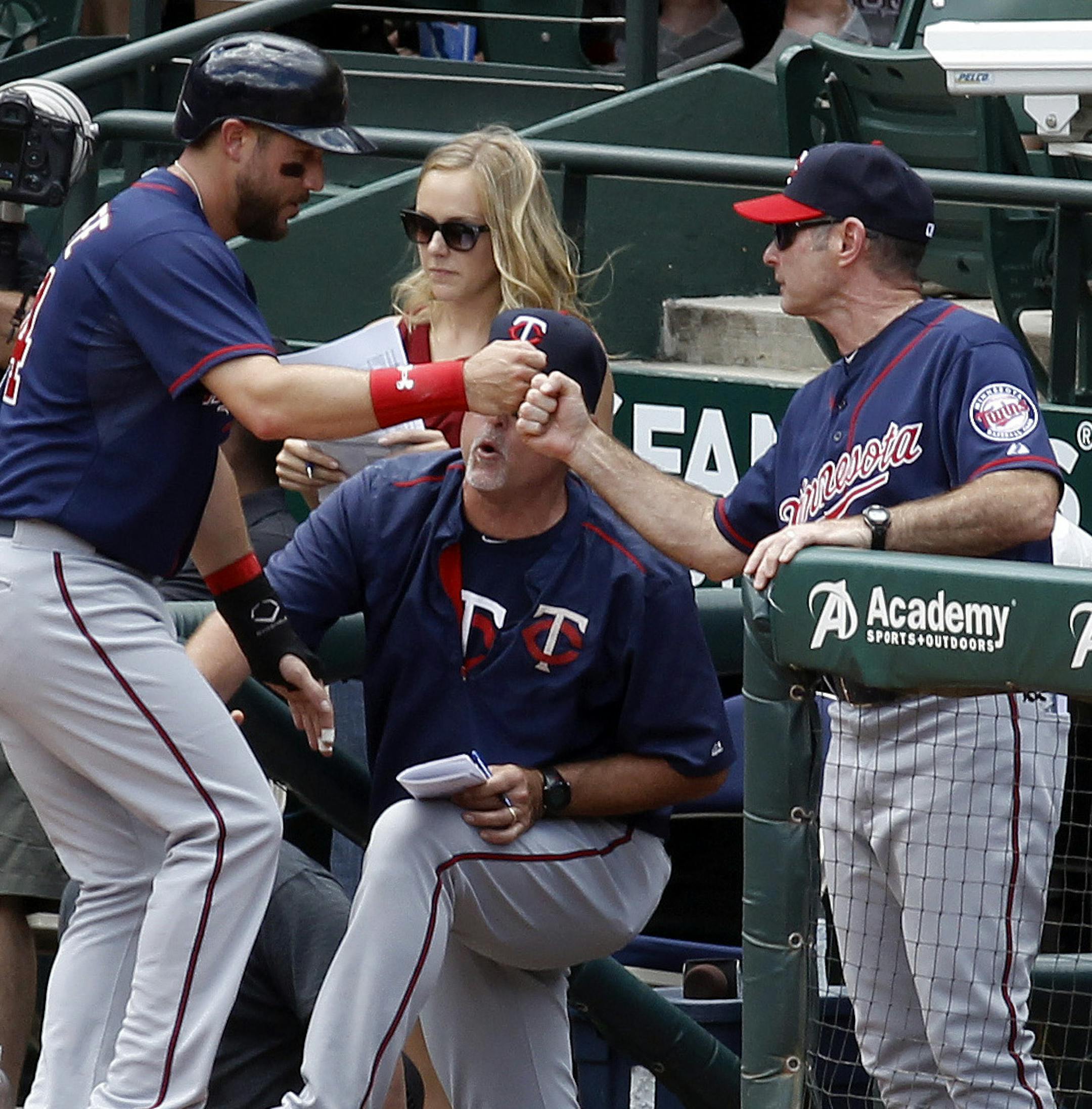 Minnesota Twins' Trevor Plouffe (24) is greeted at the dugout after scoring on a double by Eduardo Nunez during the first inning on Sunday, June 14, 2015, at Globe Life Park in Arlington, Texas. (Richard W. Rodriguez/Fort Worth Star-Telegram/TNS)
