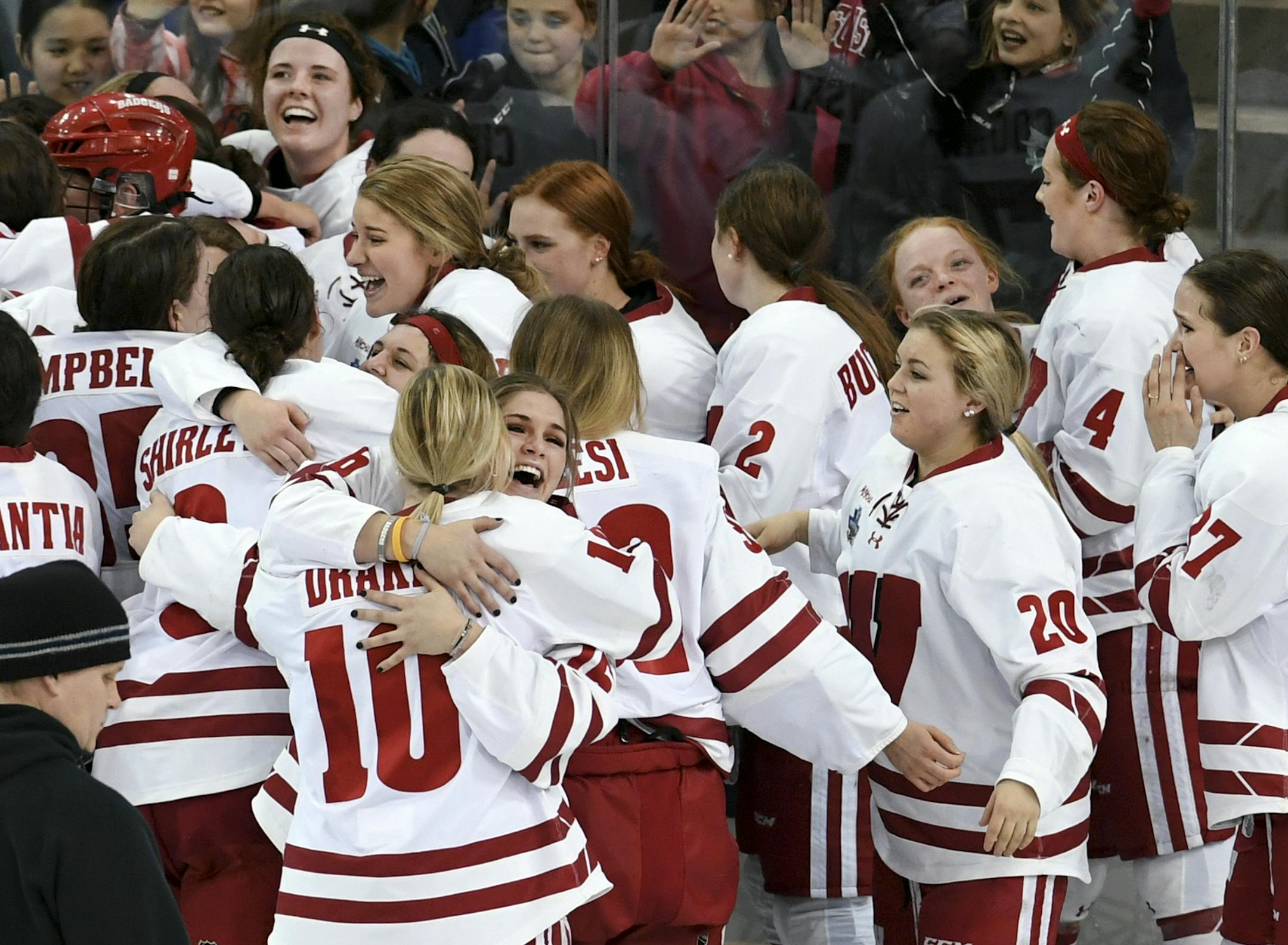 Wisconsin players gather after the team's 2-0 win over Minnesota in the NCAA Division I women's Frozen Four hockey championship final Sunday, March 24, 2019, in Hamden, Conn. (AP Photo/Stephen Dunn)