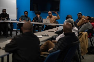 Abdisamad Nur Bidar, at the laptop, met Tuesday with the local relief committee he’s chairing for flood victims in Somalia,