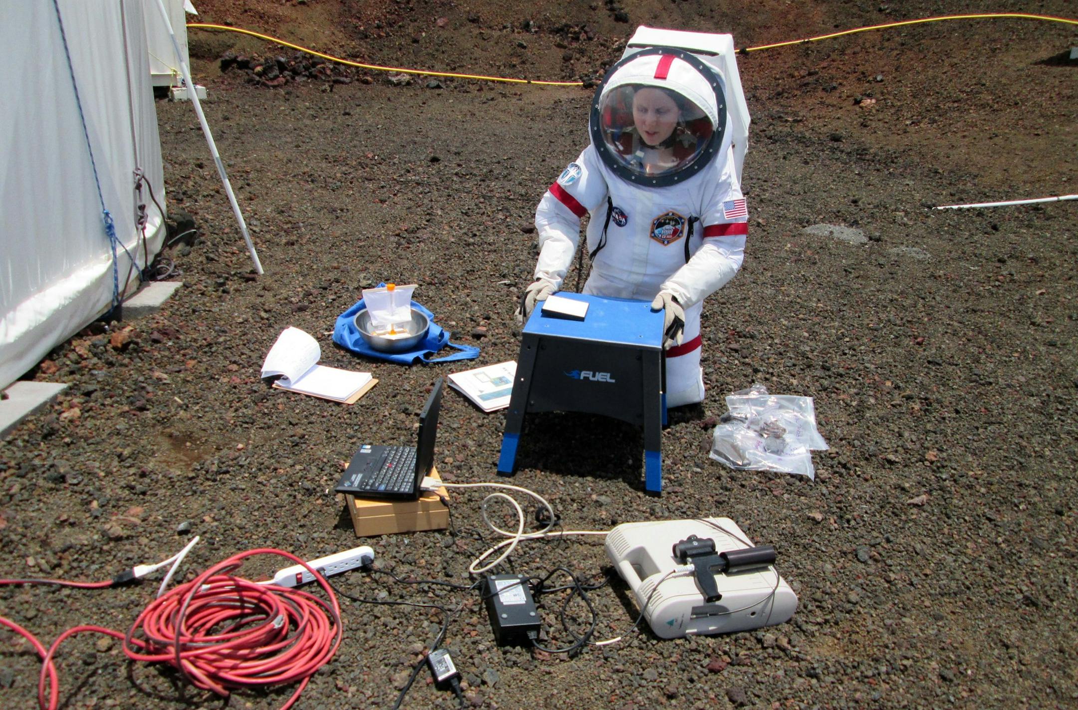 In this May 21, 2015 photo from the University of Hawaii at Manoa HI-SEAS Human Factors Performance Study, crew member Sophie Milam conducts a research project outside of the dome in which six scientists lived an isolated existence to simulate life on a mission to Mars, on the bleak slopes of dormant volcano Mauna Loa near Hilo on the Big Island of Hawaii. The scientists who took part of a human performance study funded by NASA, stepped outside the dome at 8,000 feet elevation to feel fresh air