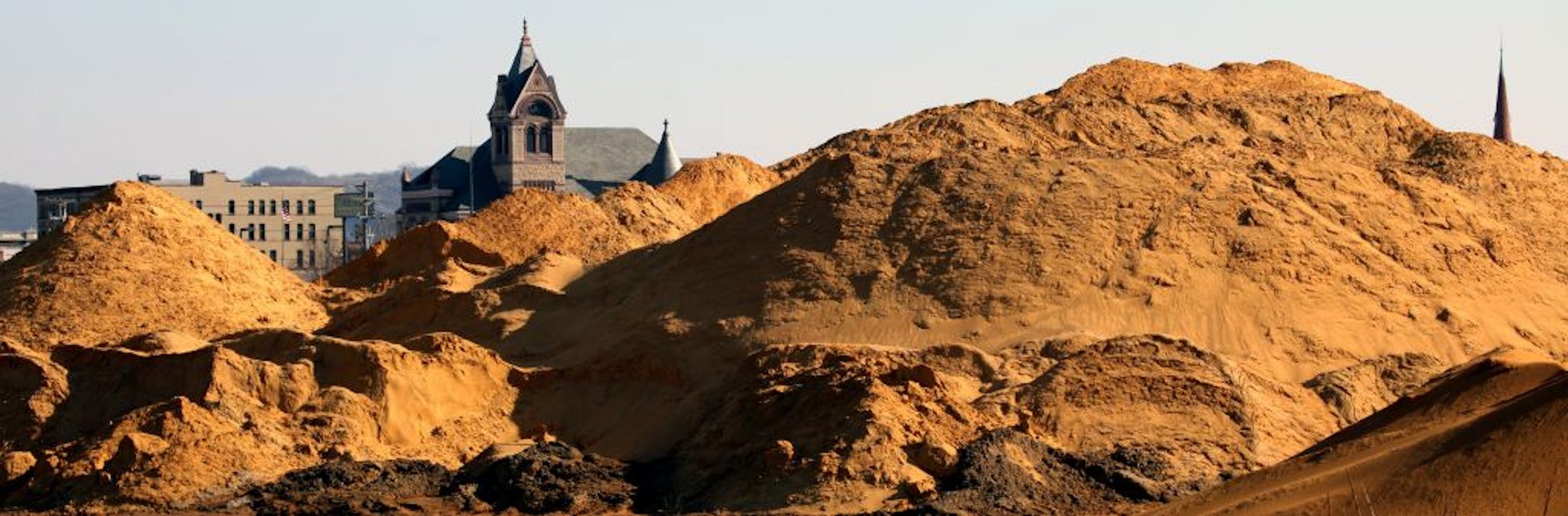 Nowhere are the concerns about sand mining, and expectations for its economic potential, more palpable than in the town of Winona. It's also becoming a lesson in how communities cope with a new industry that is booming in lock step with the business it supplies – the controversial oil and gas drilling practice called hydro fracking. (IN THIS PHOTO) A lightening rod for recent protests about sand mining is this 50,000 ton pile of sand, refered to as "Mt. Frac" in Downtown Winona. Winona County La