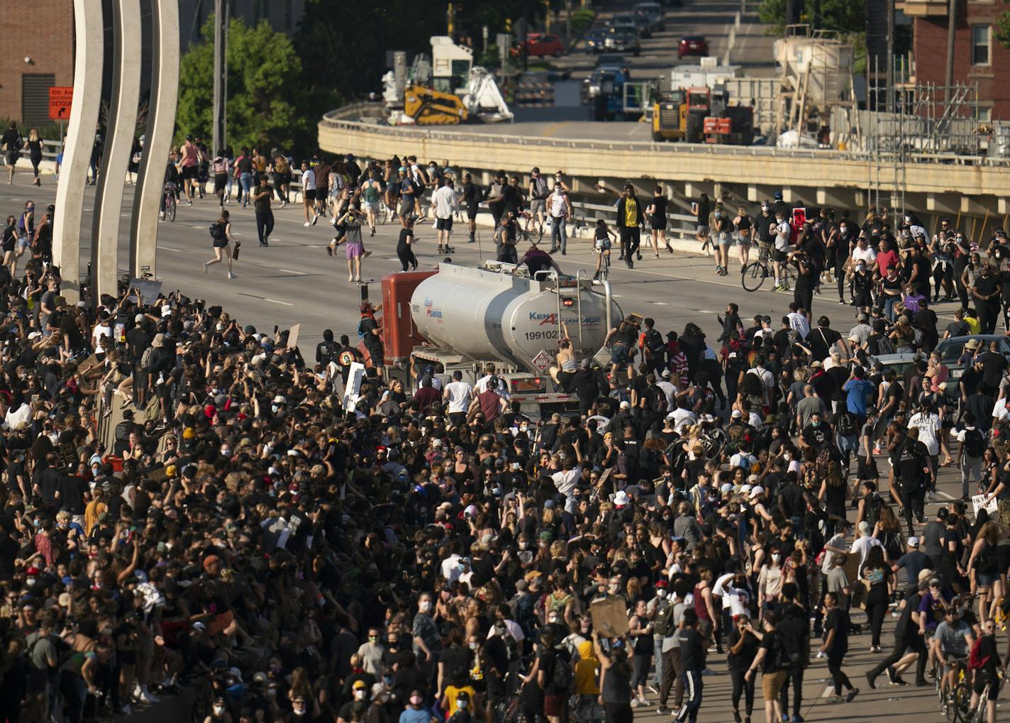 People climbed atop the tanker as continued to move after plowing into protesters who had shut down the bridge. ] JEFF WHEELER • Jeff.Wheeler@startribune.com A tanker truck plowed into a large group of demonstrators marching across the I-35W bridgeSunday evening, May 31, 2020 as they shut the highway down to protest the death of George Floyd.