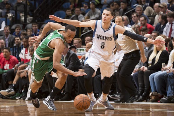 Boston Celtics guard Avery Bradley (0) knocks the ball loose for a steal from Minnesota Timberwolves guard Zach LaVine (8) during the second quarter.