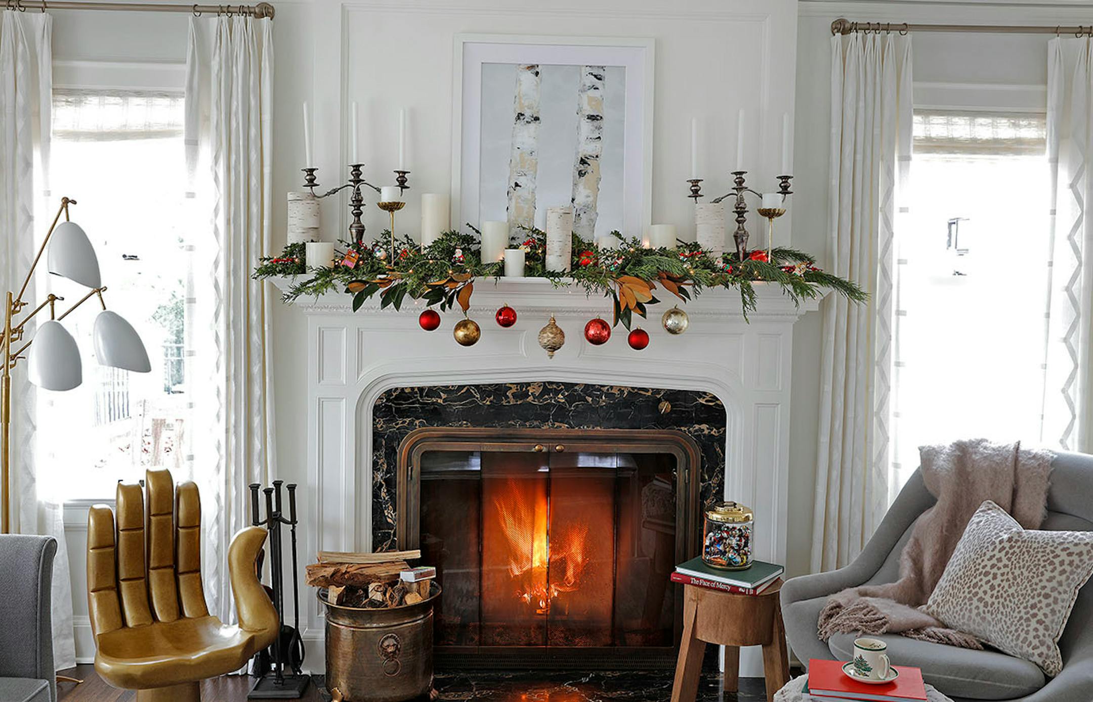 Krystal Kellermann, interior designer for Martha O'Hara Interiors, shows how to create a mantel vignette with an ornament collection. The artwork above the fireplace is by Janella Fesenmaier, Art Resources Gallery.