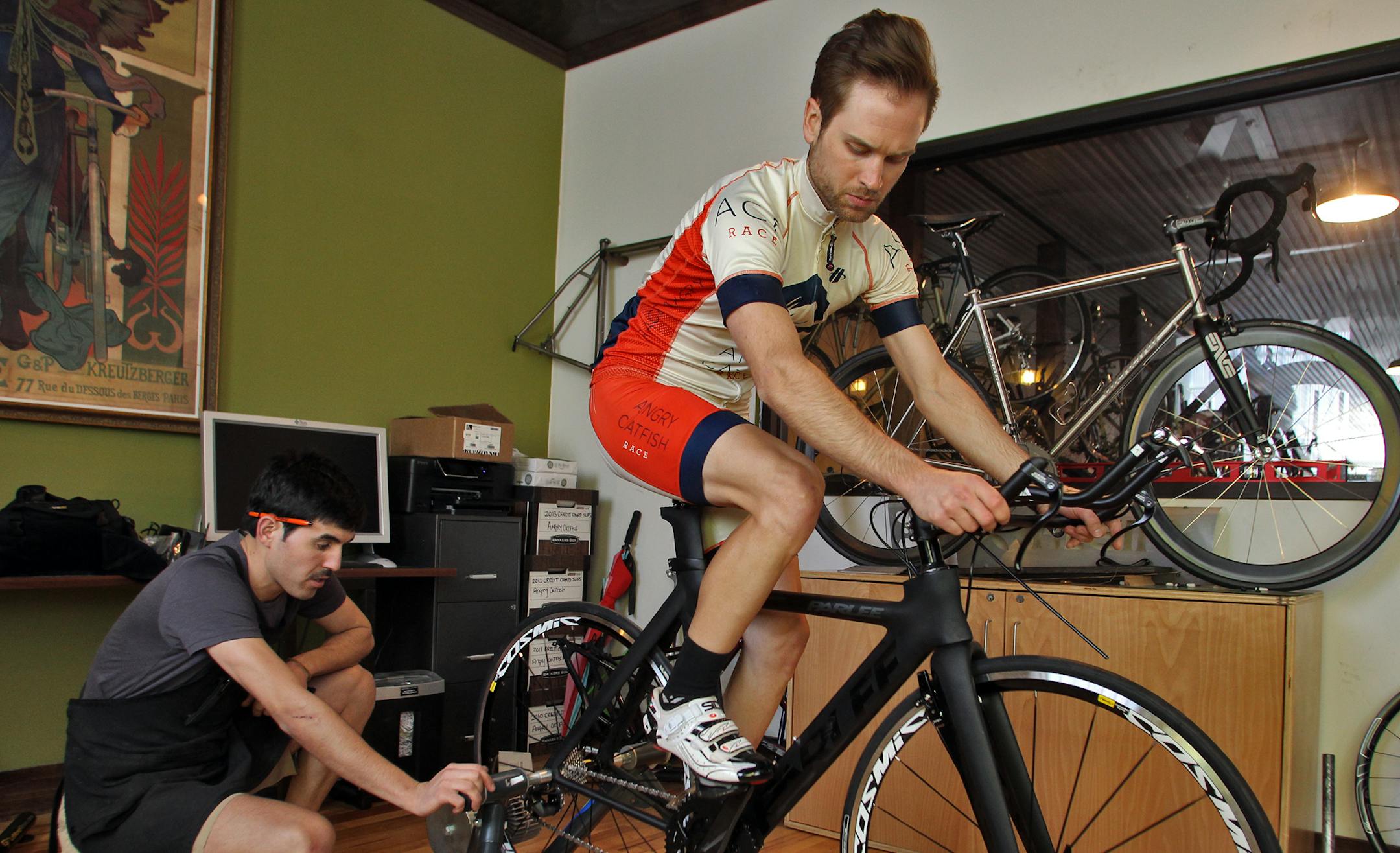 Nick Valdes, left, sales person at Angry Catfish Bike Shop in Minneapolis, fitted a new Parlee racing bike to customer Mark Stephany, Minneapolis. (MARLIN LEVISON/STARTRIBUNE(mlevison@startribune.com (cq )