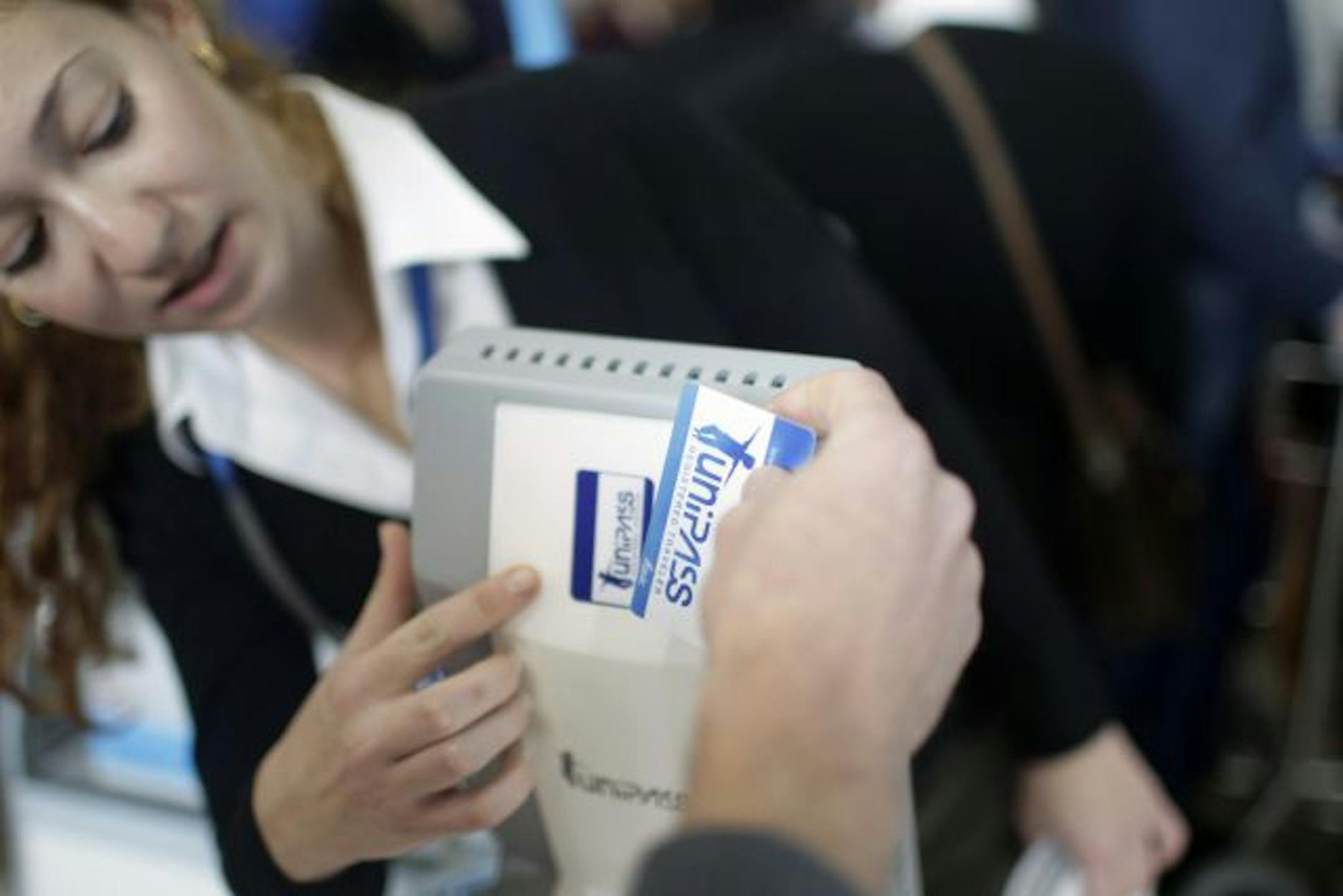 A passenger is helped to use the biometrics identification system to go through the security checks at Ben Gurion airport near Tel Aviv, Israe.