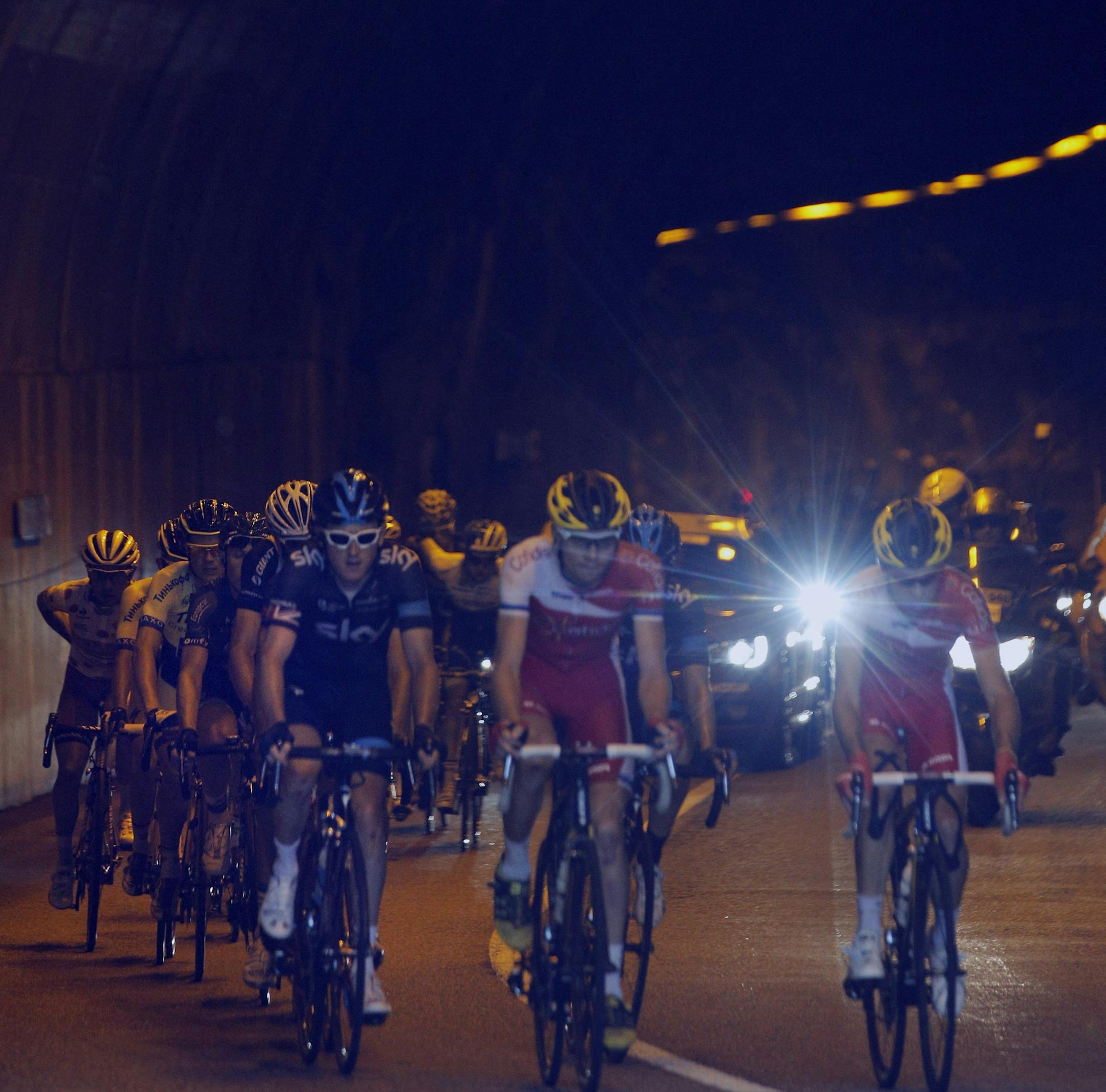 The pack rides through a tunnel during the fourteenth stage of the Tour de France cycling race over 177 kilometers (110 miles) with start in Grenoble and finish in Risoul, France, Saturday, July 19, 2014. (AP Photo/Christophe Ena)