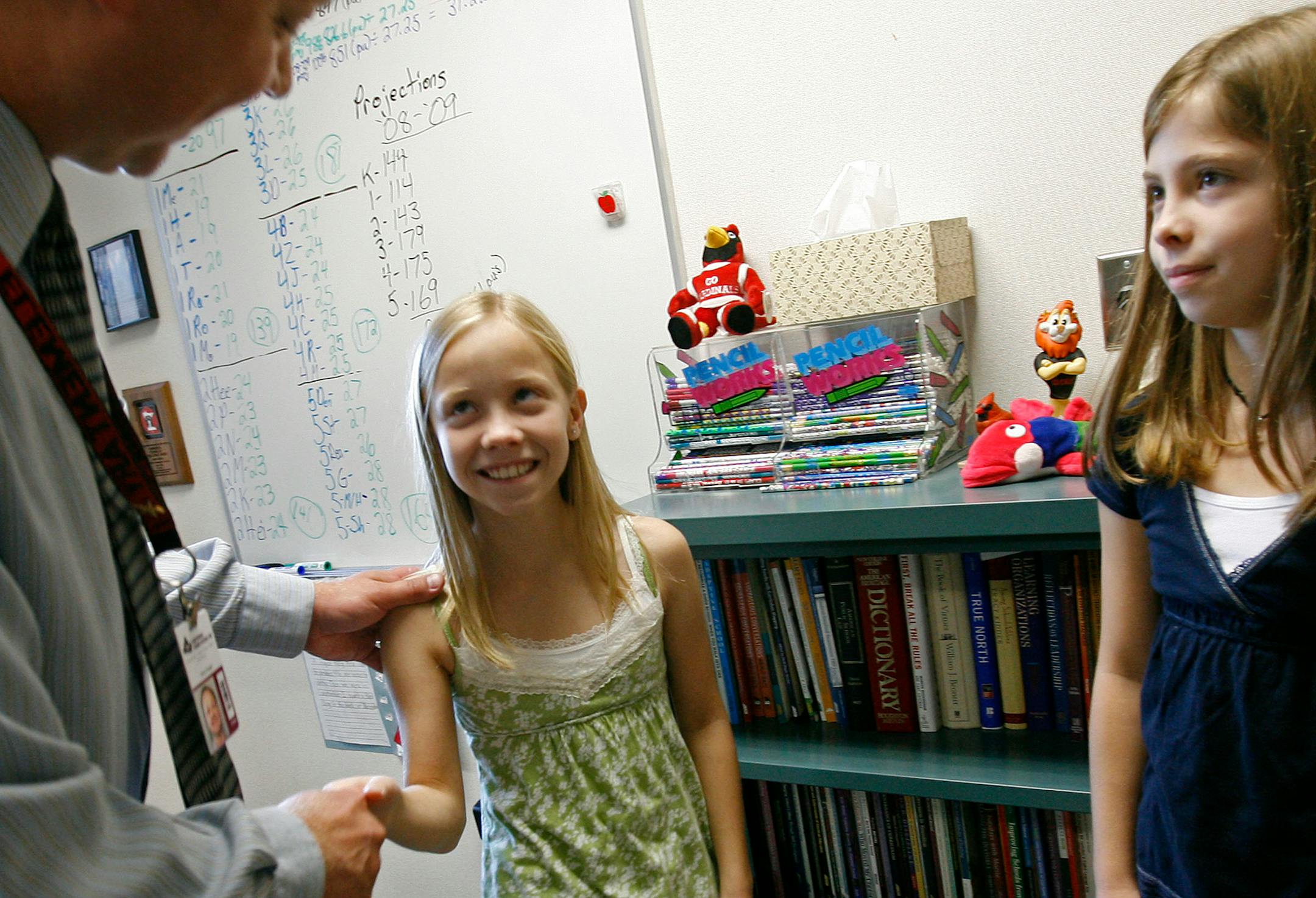 Red Pine Elementary Principal Gary Anger congratulated twin sisters Madison, center, and Emily Sides, who turned 10 Wednesday. The school doesn't allow sharing birthday treats.