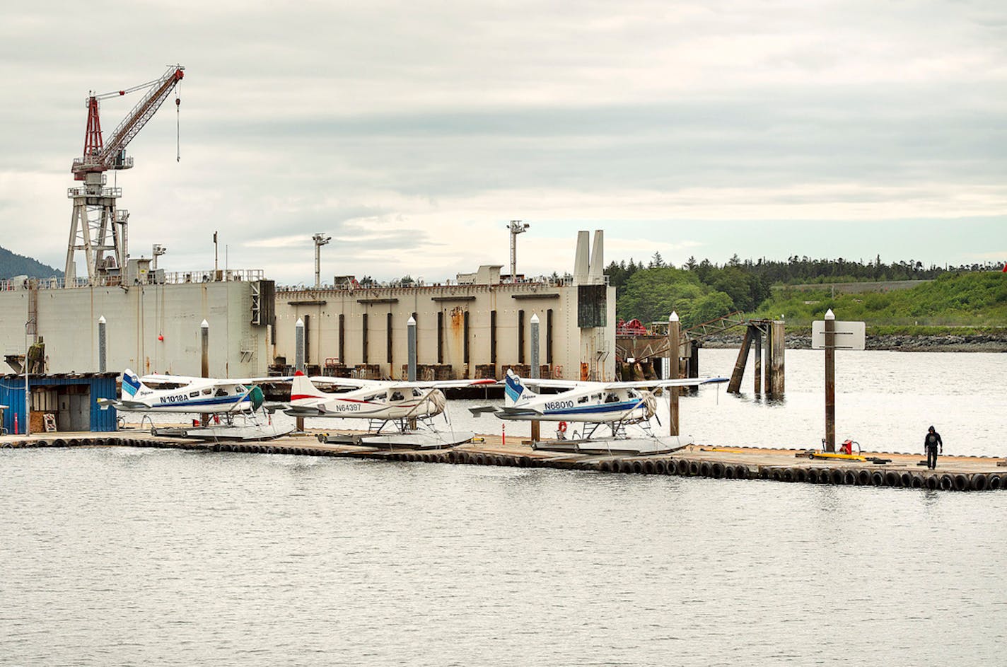 A worker tends to a vacant float plane slip at the Taquan Air docks near the Vigor Alaska shipyard in Ketchikan, Alaska, Tuesday, May 21, 2019.